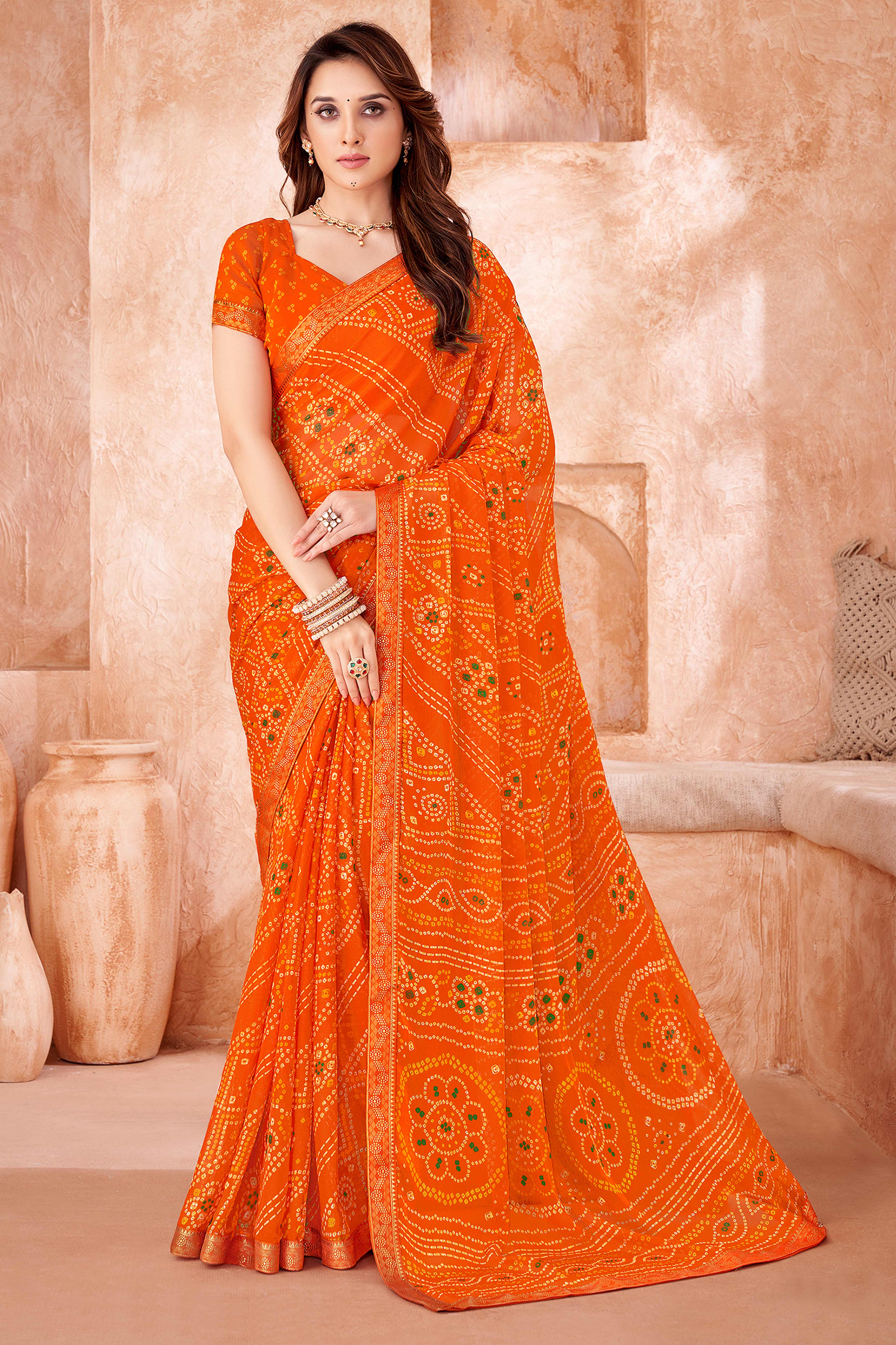 Orange Chiffon Saree Featuring Traditional Bandhani Prints & A Graceful Lace Edge