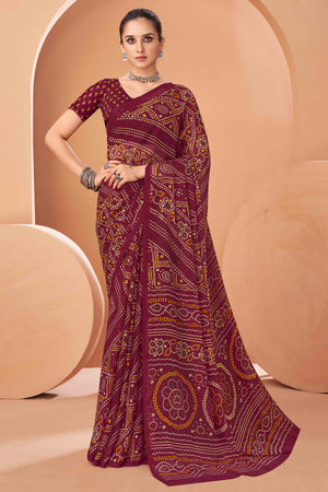 Maroon Bandhani Printed Chiffon Saree Accented With Intricate Lace Border Work