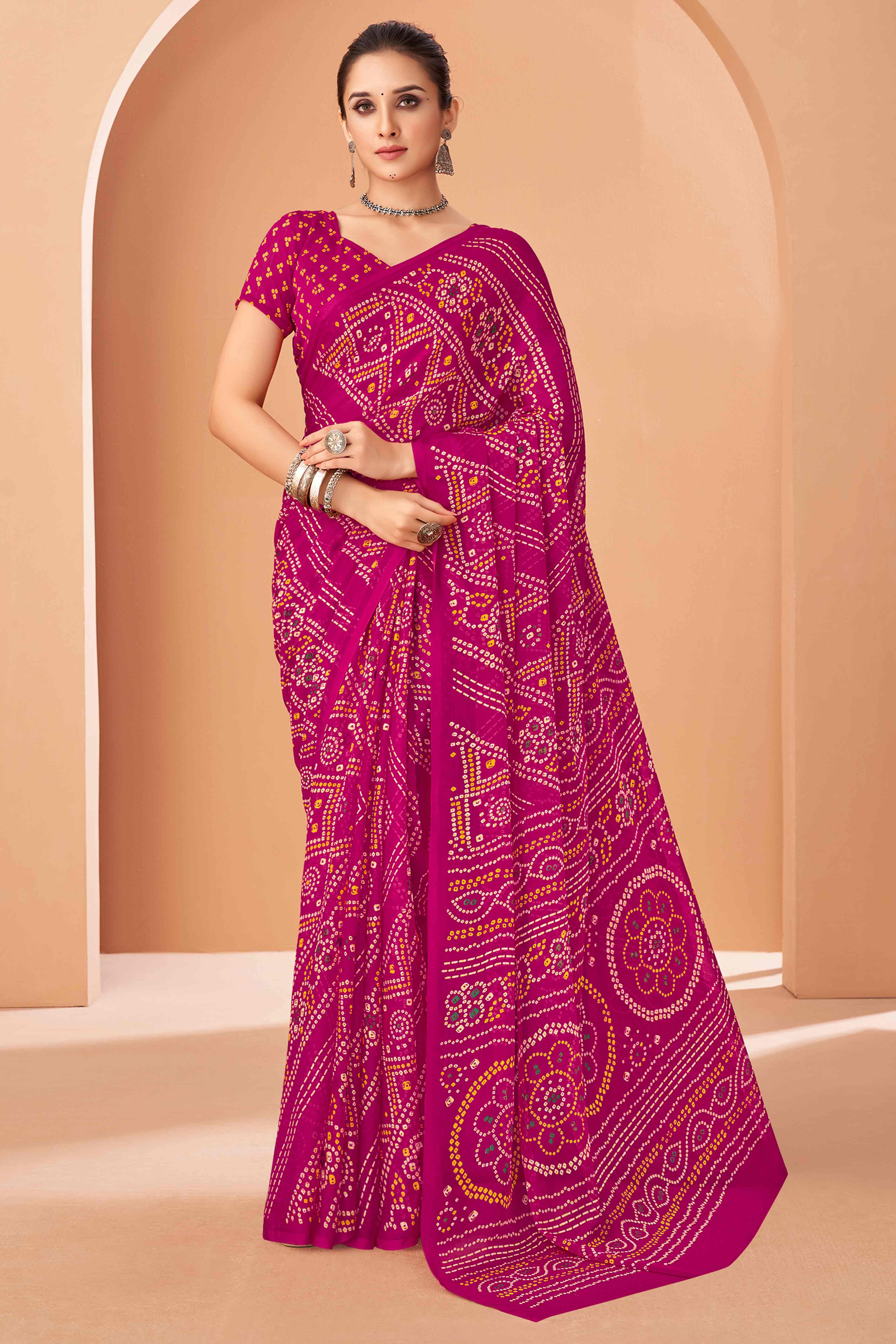 Magenta Bandhani Printed Chiffon Saree Accented With Intricate Lace Border Work