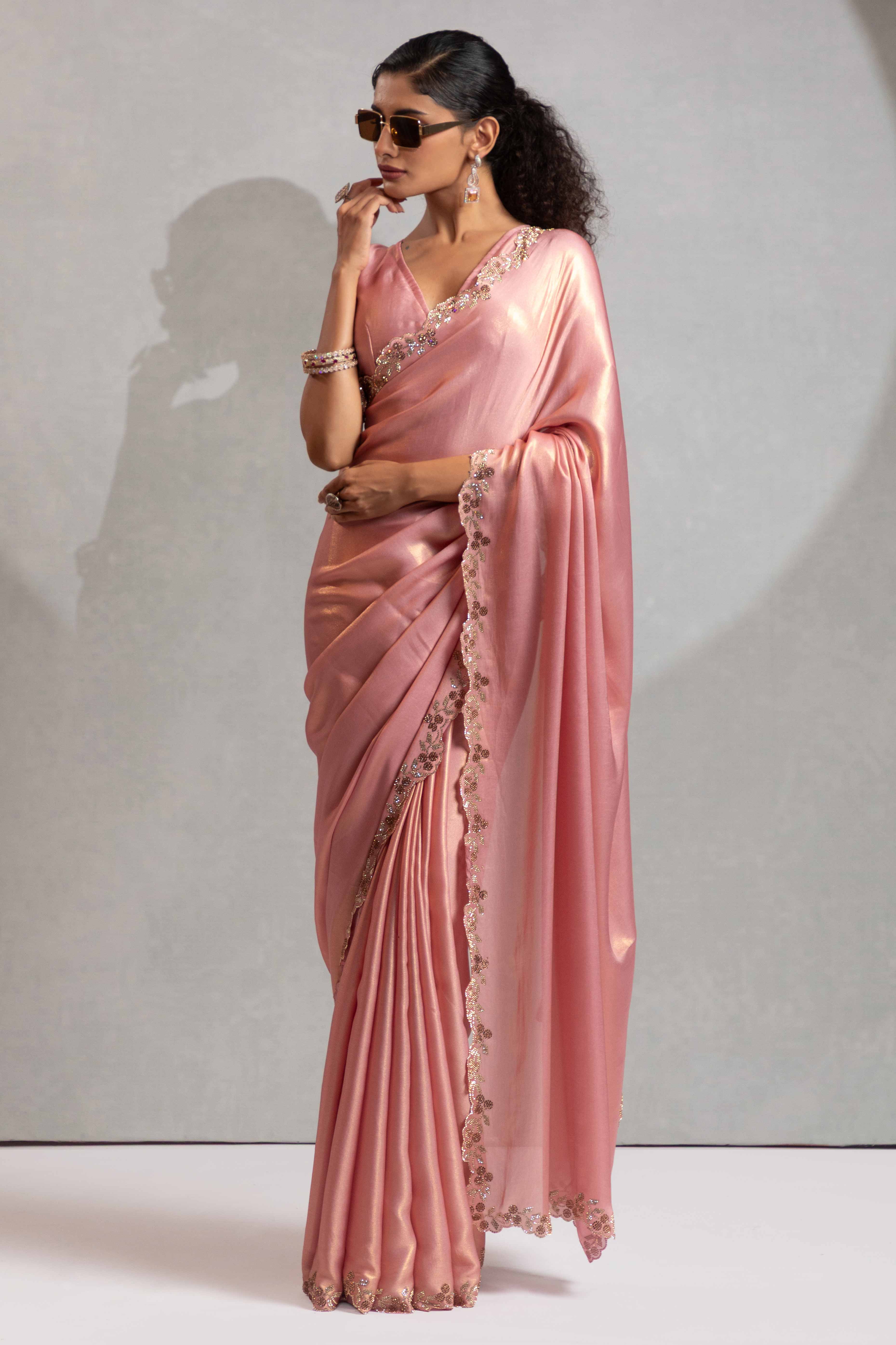 Peach Satin Georgette Saree Adorned With Subtle Foil Finish & A Sparkling Zarkan Work Border