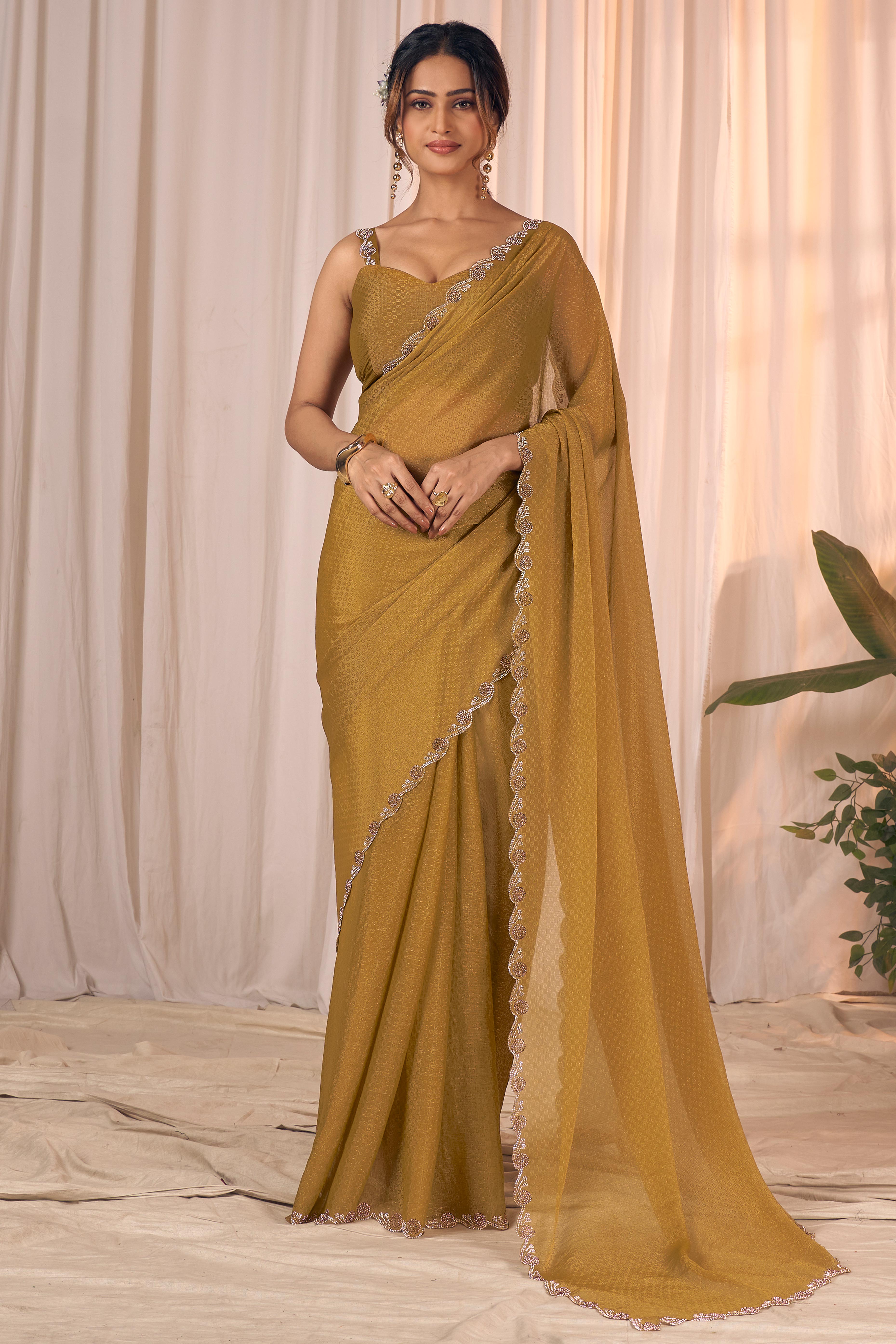 Designer Golden Bronze Georgette Saree Adorned With An Elegant Zarkan Cutwork Border