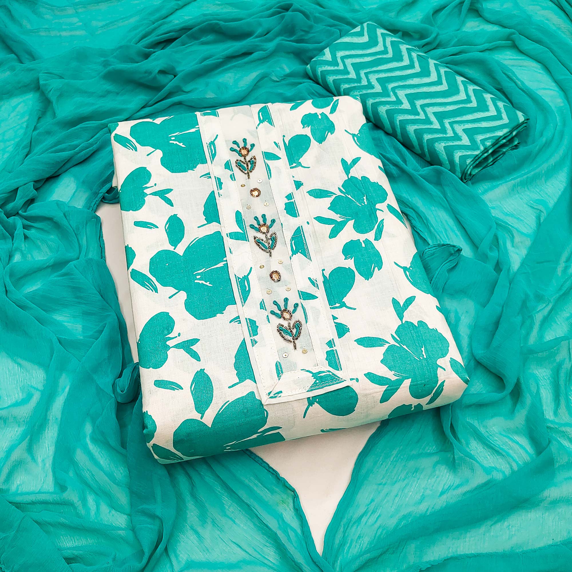 White Base Pure Cotton Dress Material Accented with Beautiful Turquoise Florals