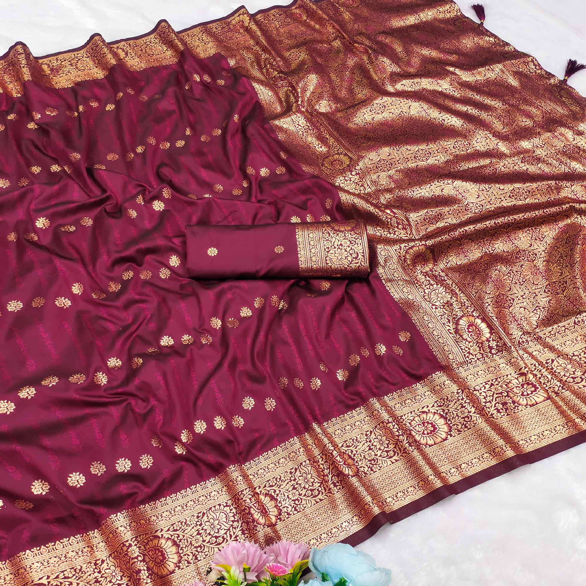 Wine Zari-Woven Cotton Silk Saree Featuring a Graceful Drape and Delicate Tassel Detailing