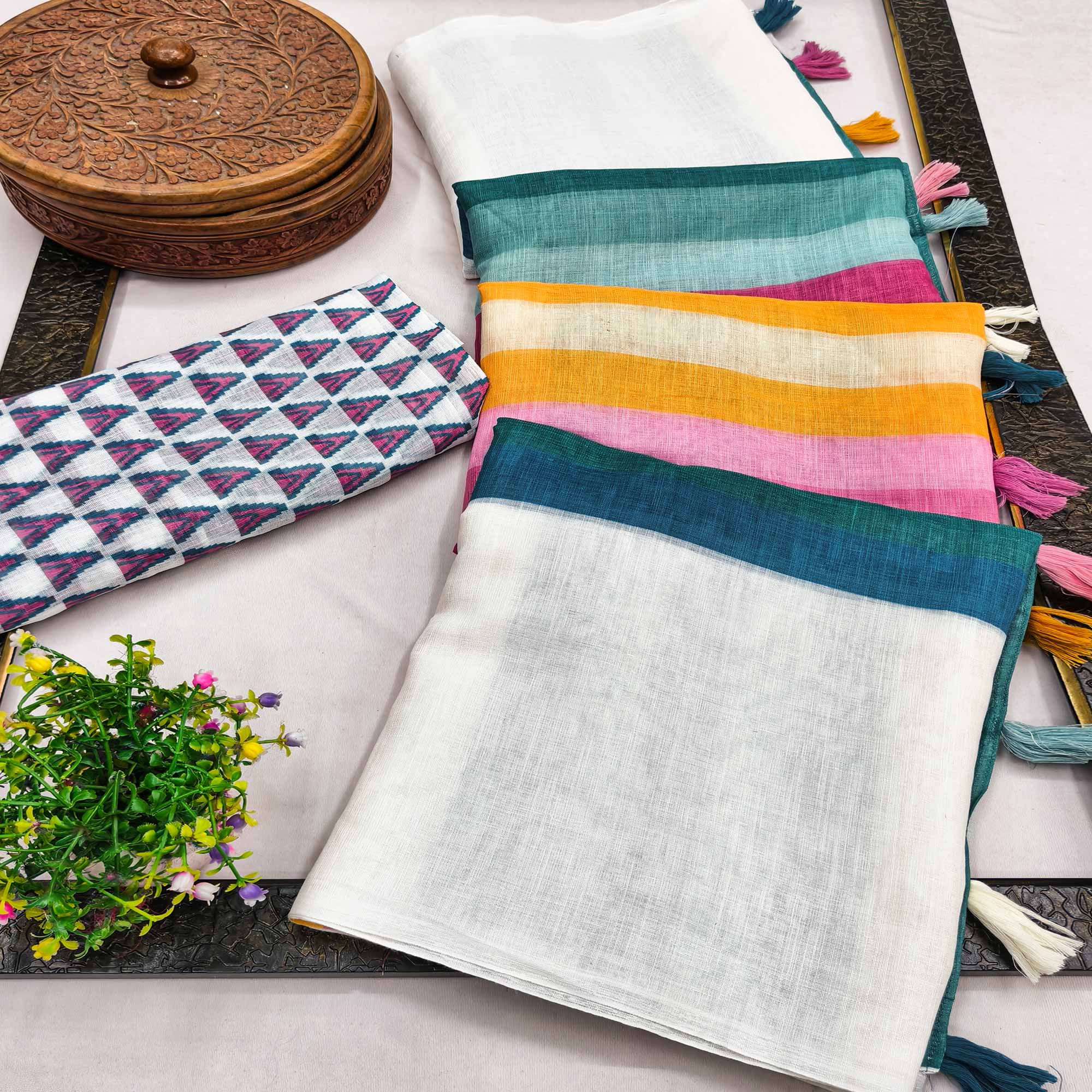 White Linen Saree Designed with Modern Striped Prints and Trendy Tassel Detailing