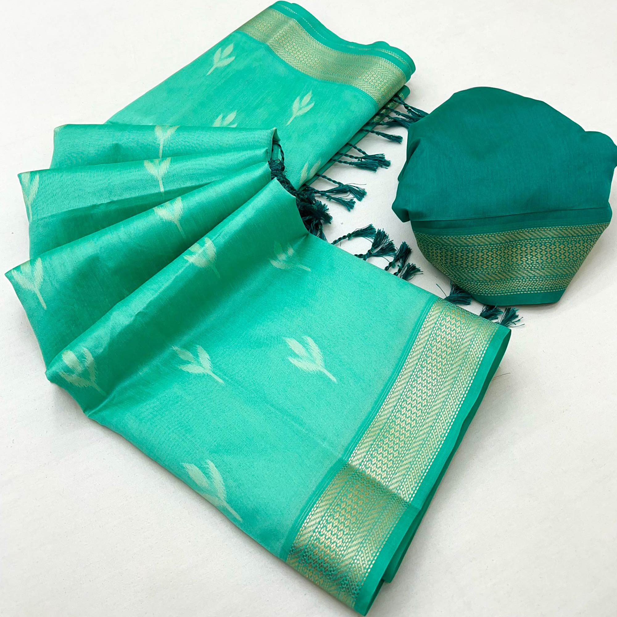 Turquoise Ikkat Style Rayon Silk Saree with Luxurious Zari Border and Delicate Tassels