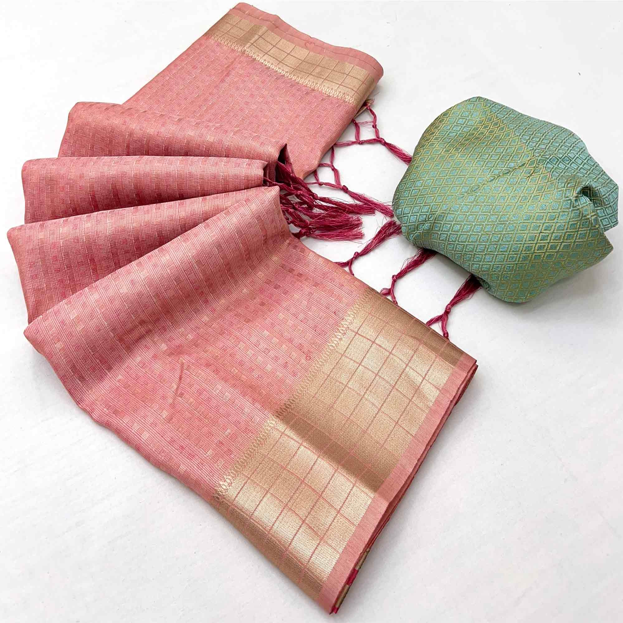 Peach Soft Tissue Saree Featuring Rich Zari Woven Detailing.