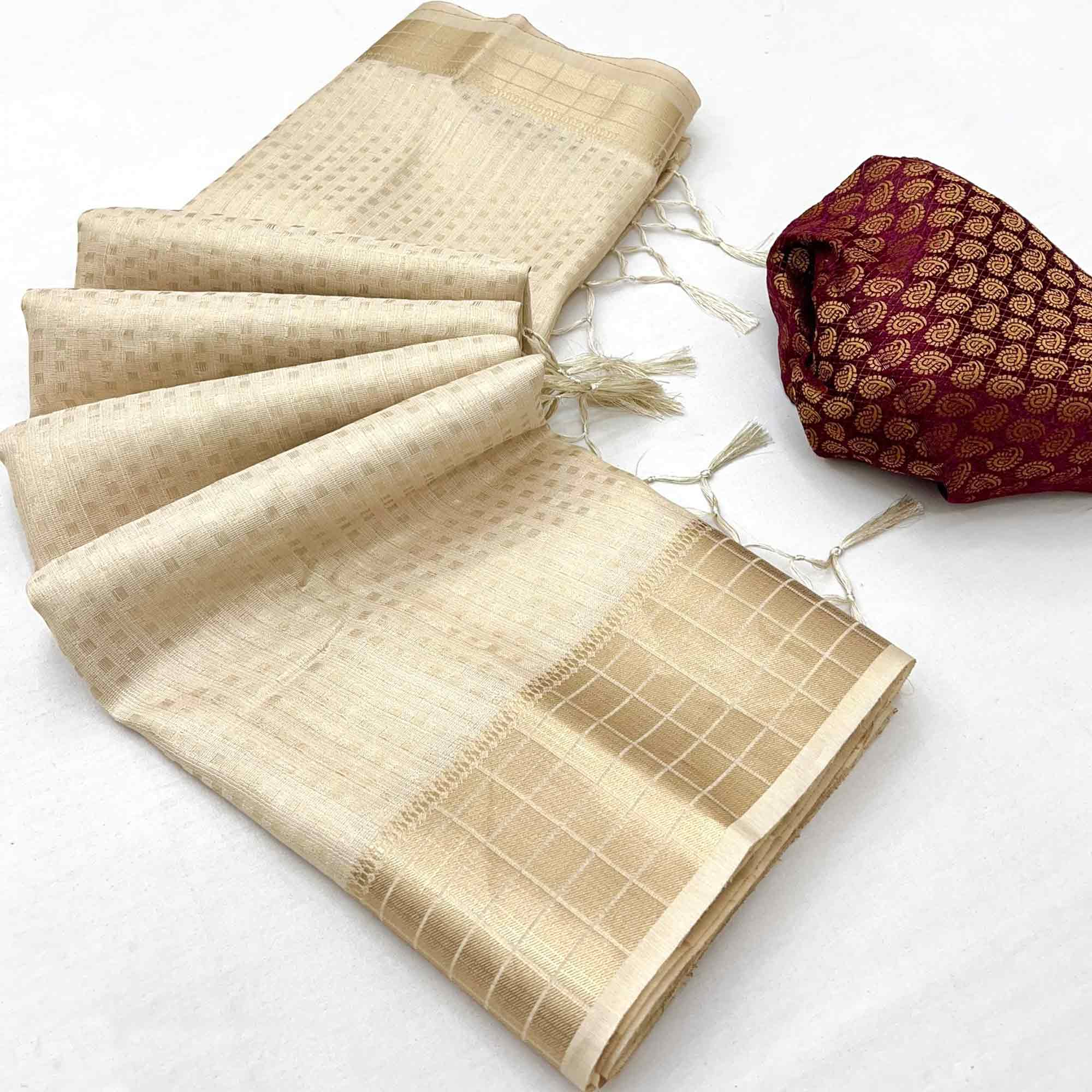 Cream Soft Tissue Saree Featuring Rich Zari-Woven Detailing.