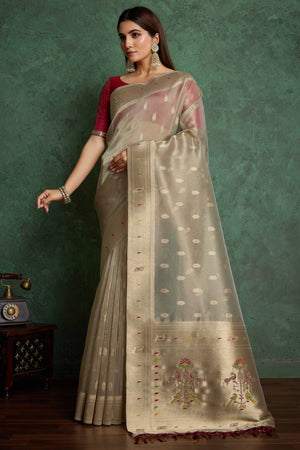Graceful Beige Floral Woven Tissue Saree Adorned With Shimmering Jarkan Work & Tassel Pallu