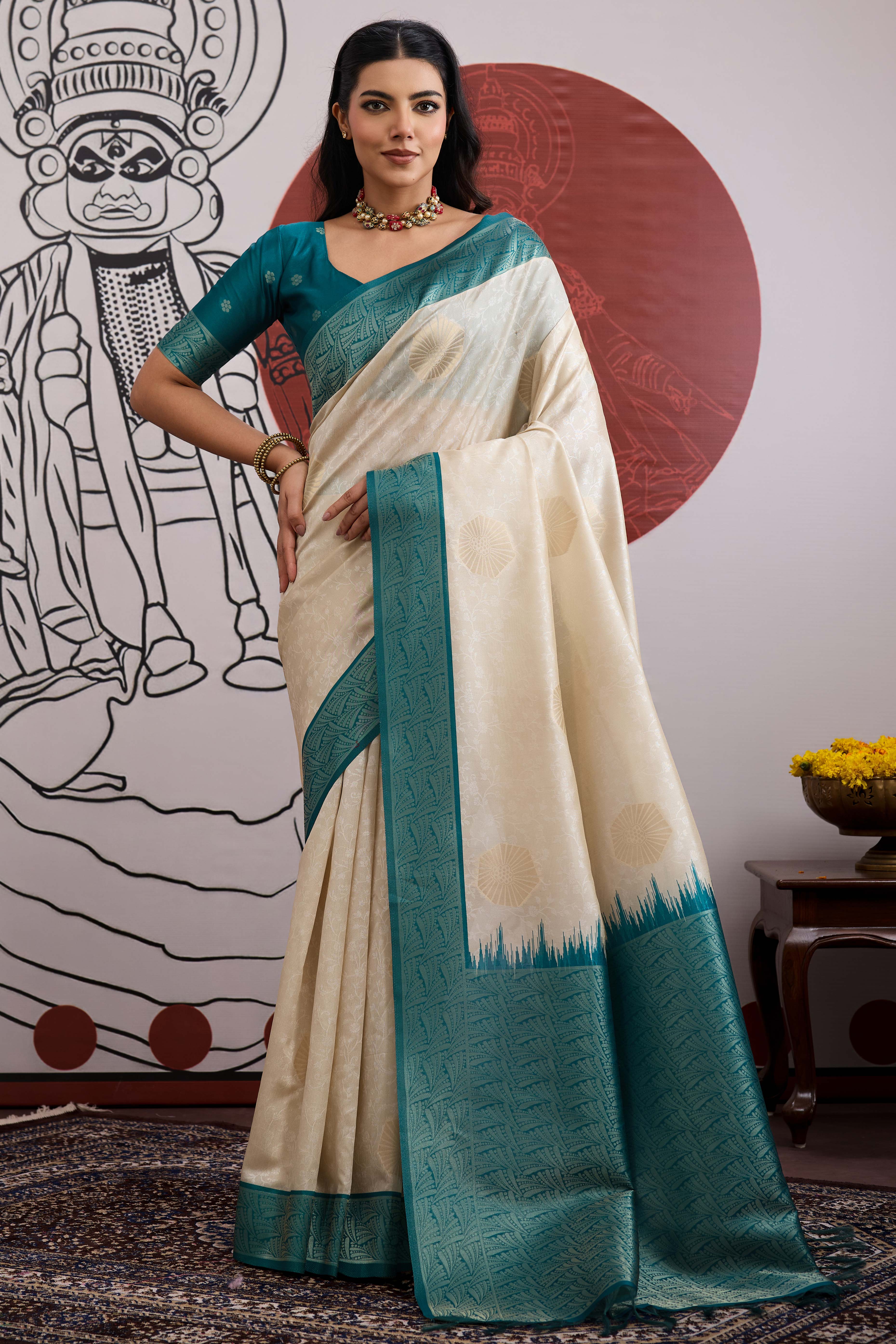Graceful Cream & Teal Zari Weaving Silk Saree Highlighted By Decorative Tassel Pallu