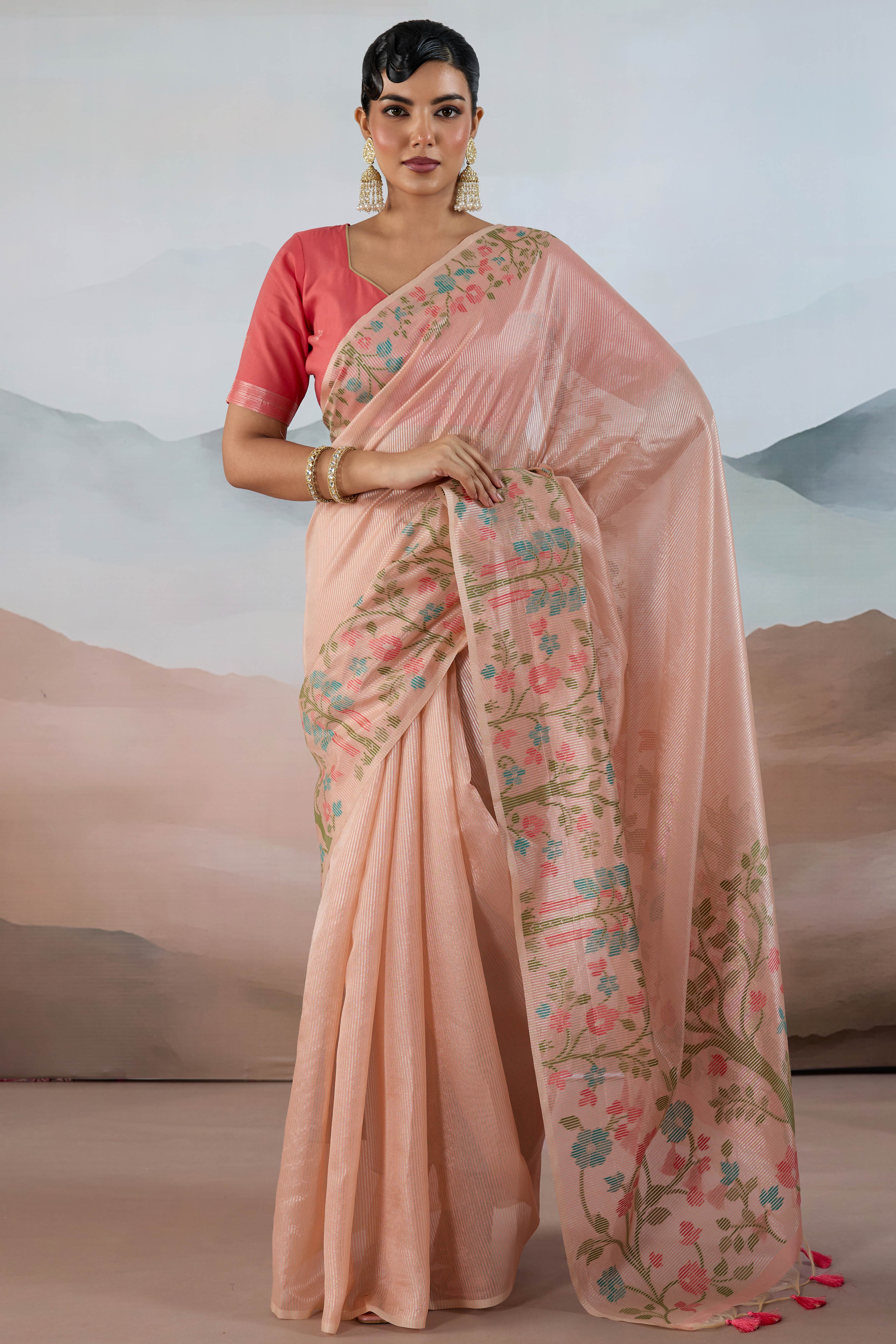 Peach Tissue Silk Saree Showcasing Floral & Striped Weaving With Tassel Adornment