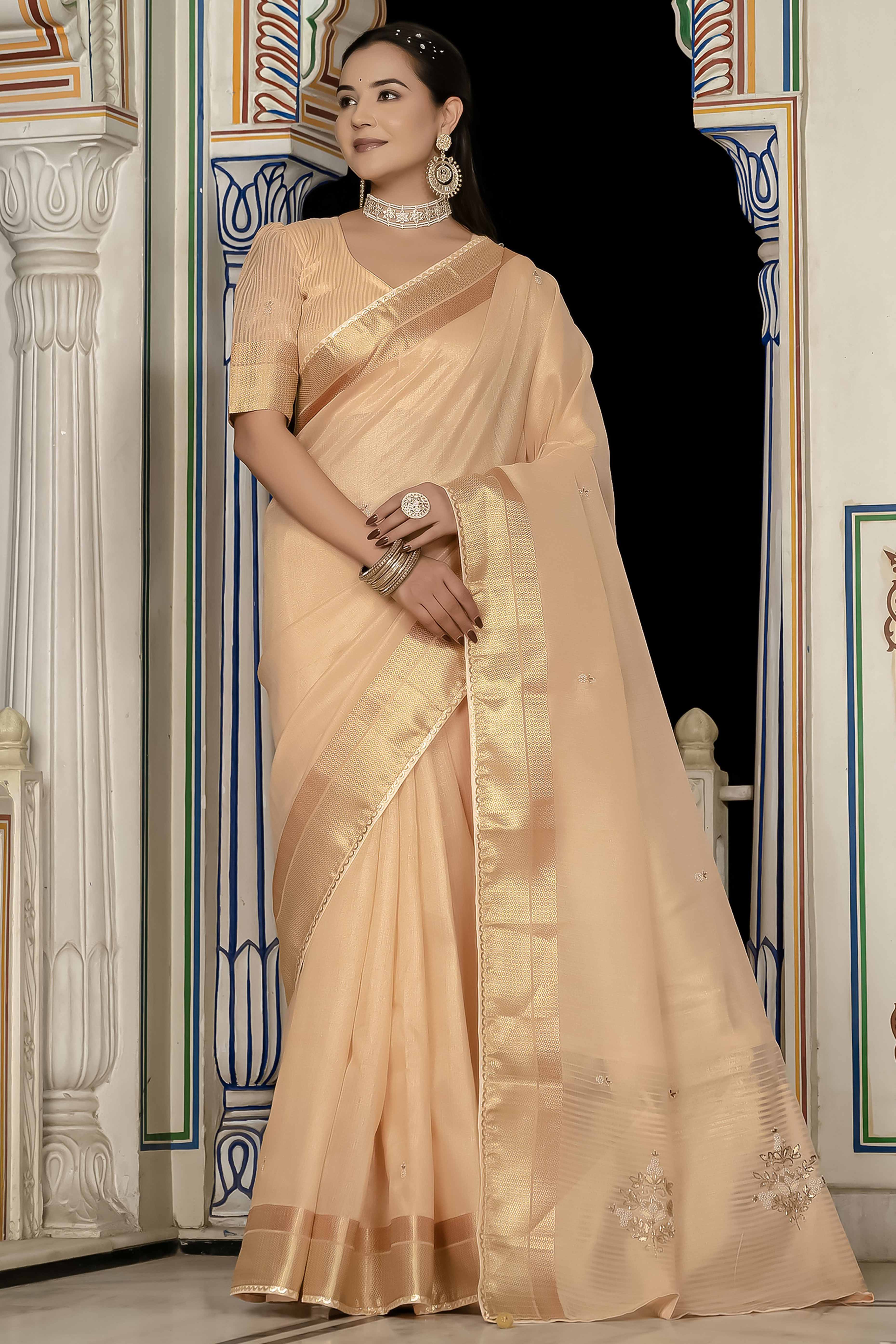 Peachy Beige Tissue Linen Saree Featuring Intricate Zari and Beadwork