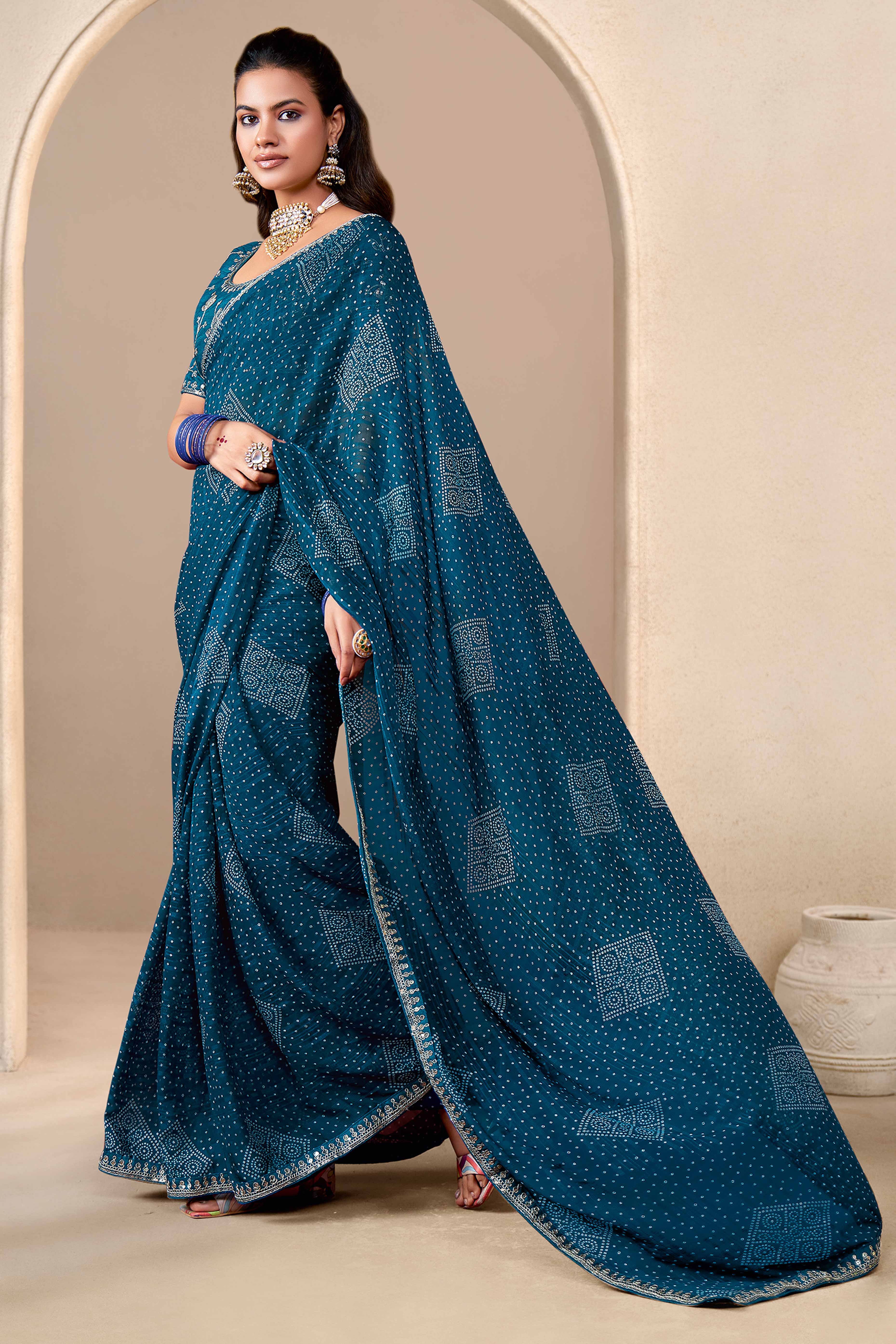 Teal Blue Bandhani Printed Georgette Saree Enhanced With Sequins & Cording Embroidered Lace Border