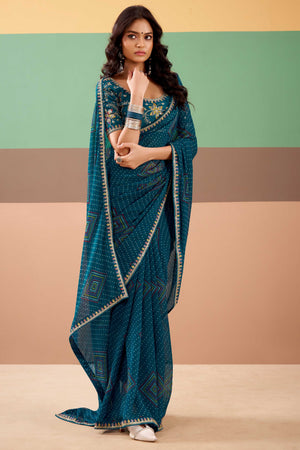 Charming Teal Bandhani Printed Georgette Saree Adorned With Intricate Cording Embroidered Border