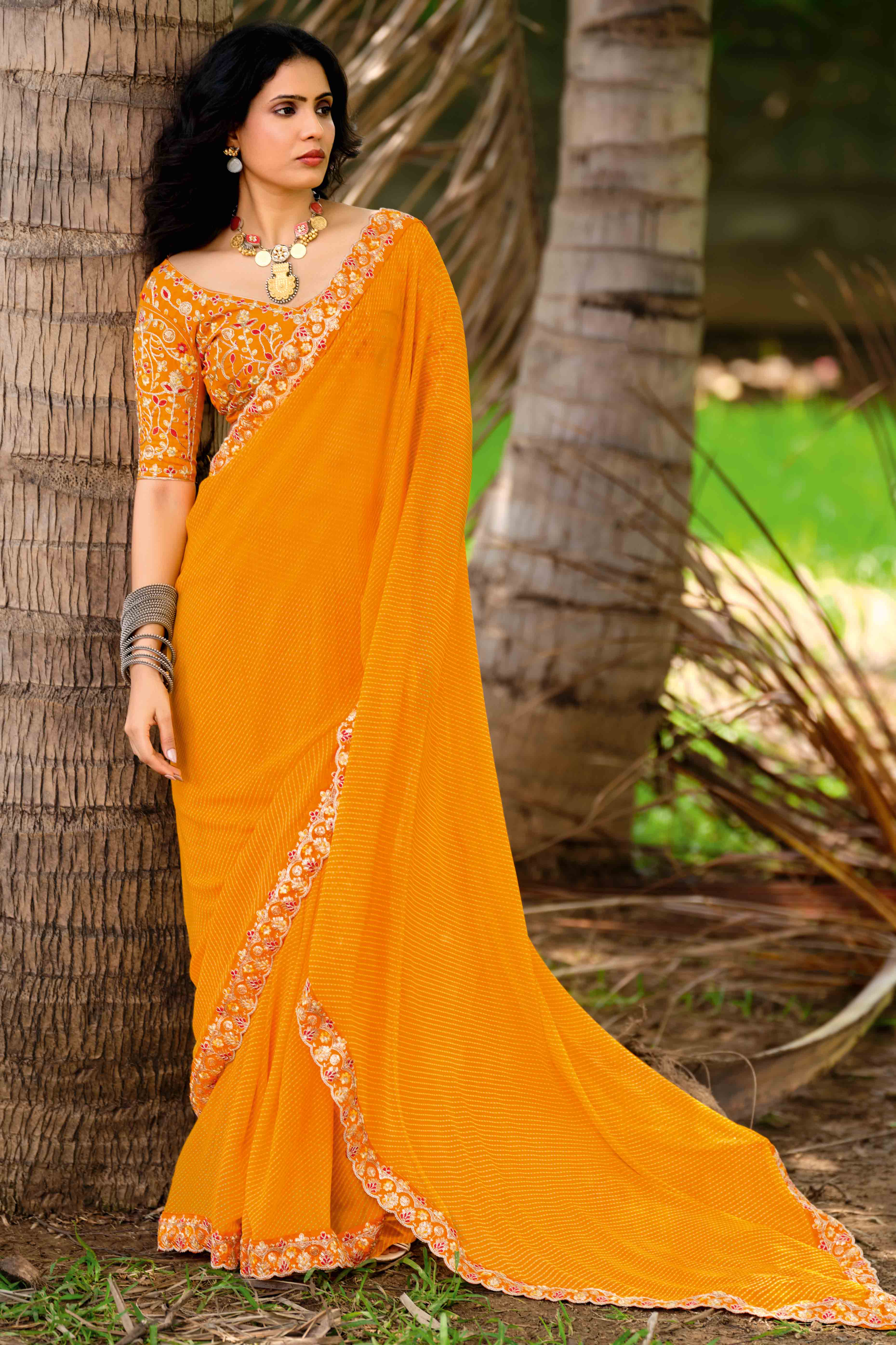 Bright Orange Striped Printed Georgette Saree With Shimmering Sequin Embroidered Border