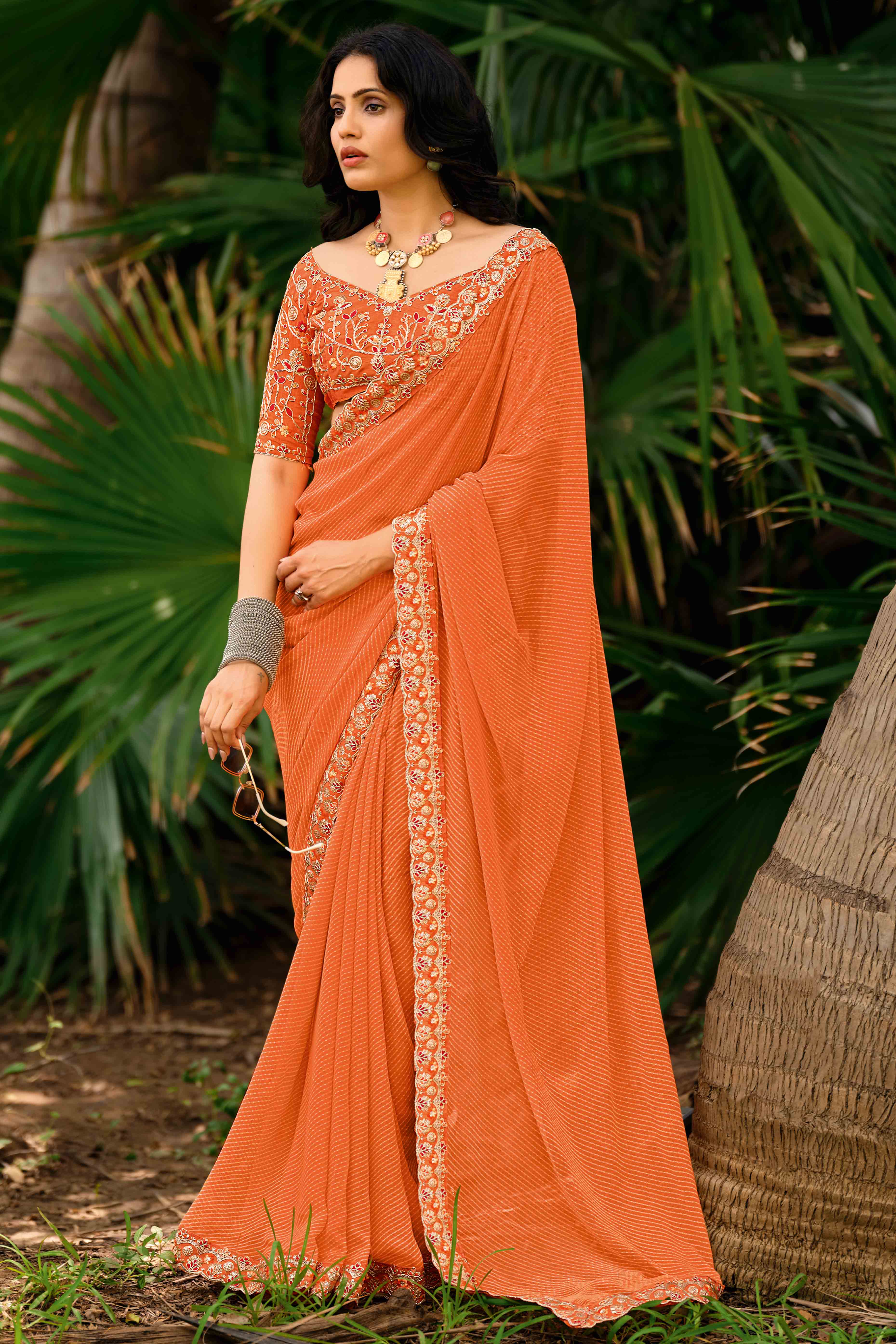 Orange Striped Printed Georgette Saree With Shimmering Sequin Embroidered Border
