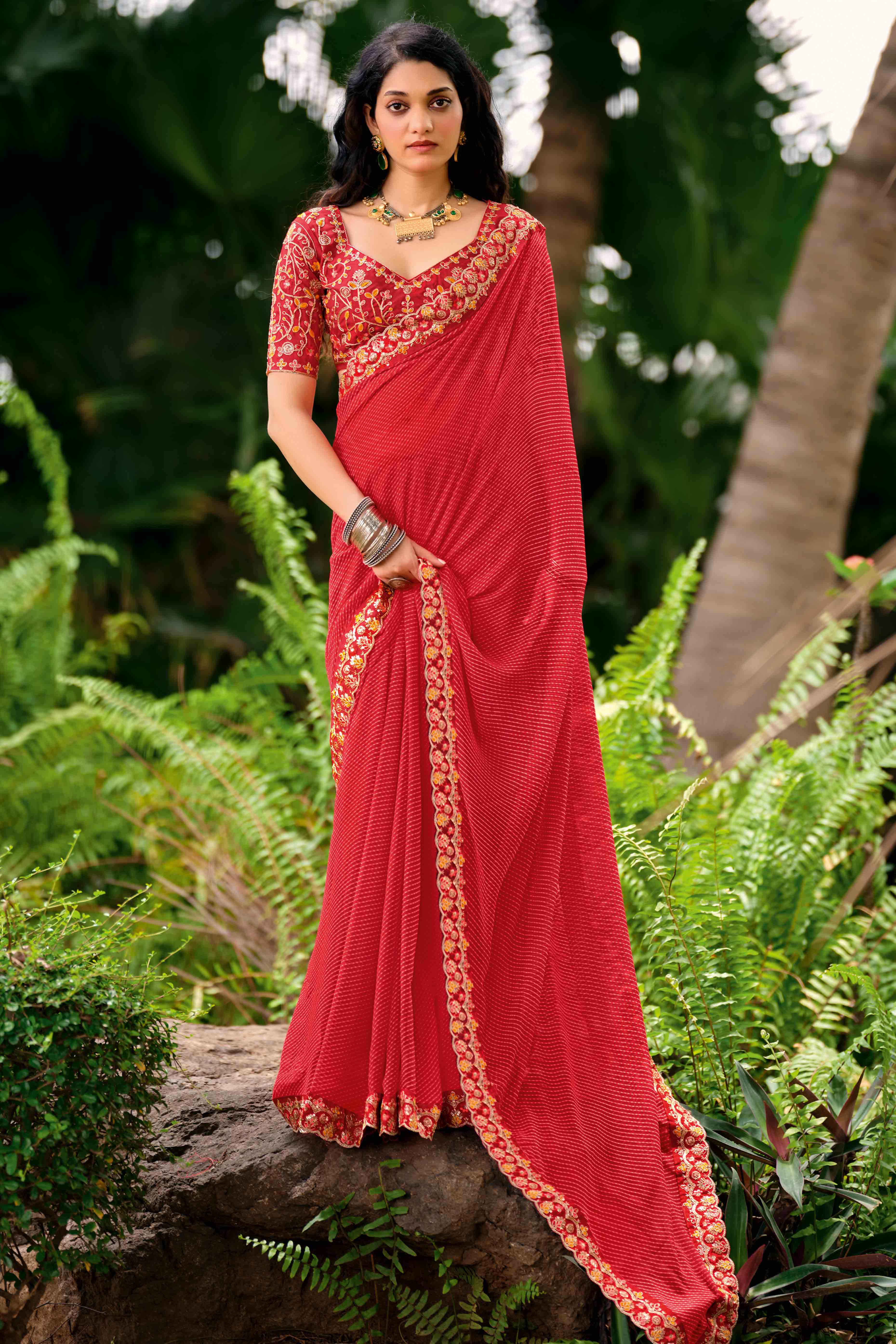 Coral Red Striped Printed Georgette Saree With Shimmering Sequin Embroidered Border
