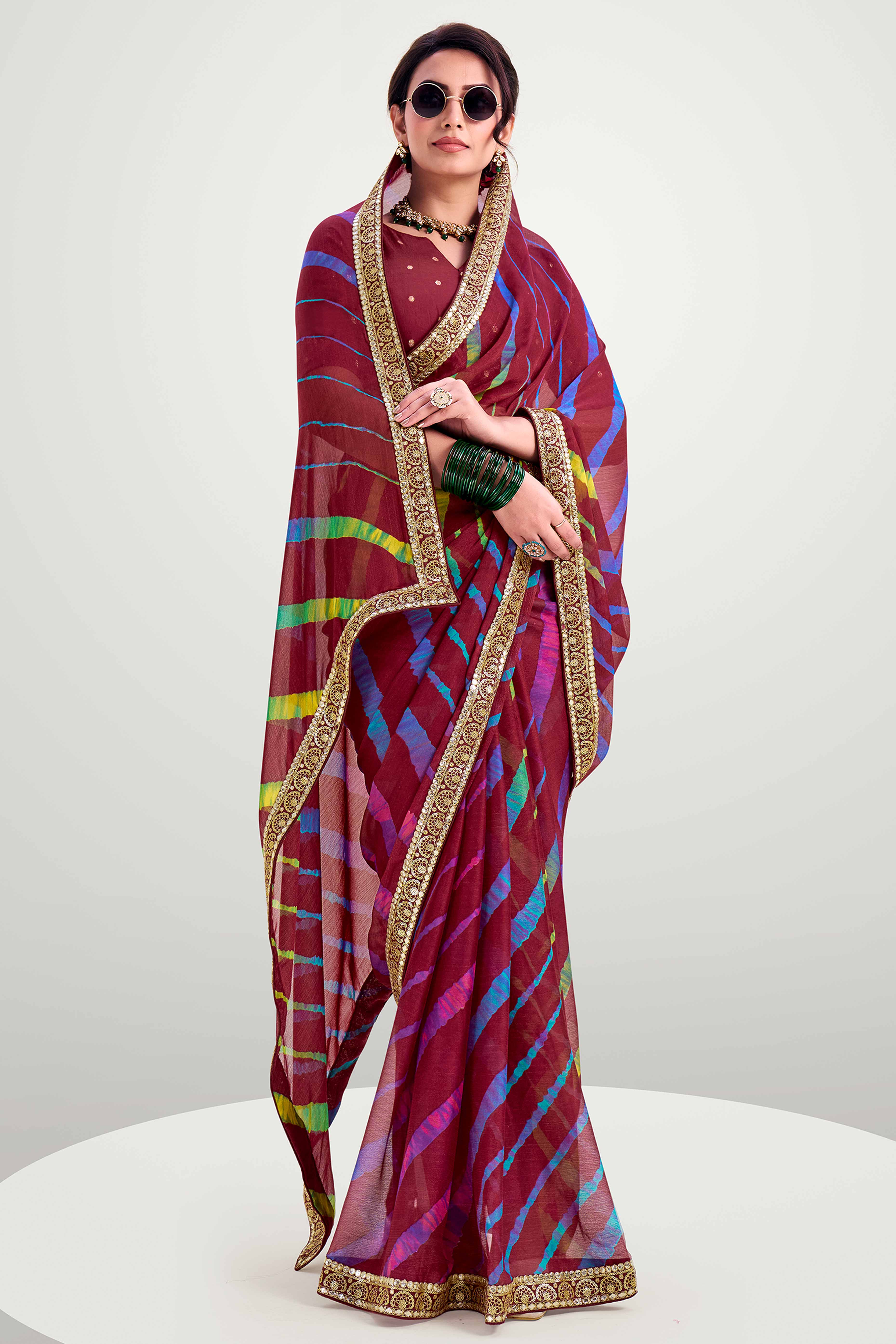 Maroon Striped Printed Chiffon Saree Enhanced With Sparkling Sequins Embroidered Border Work