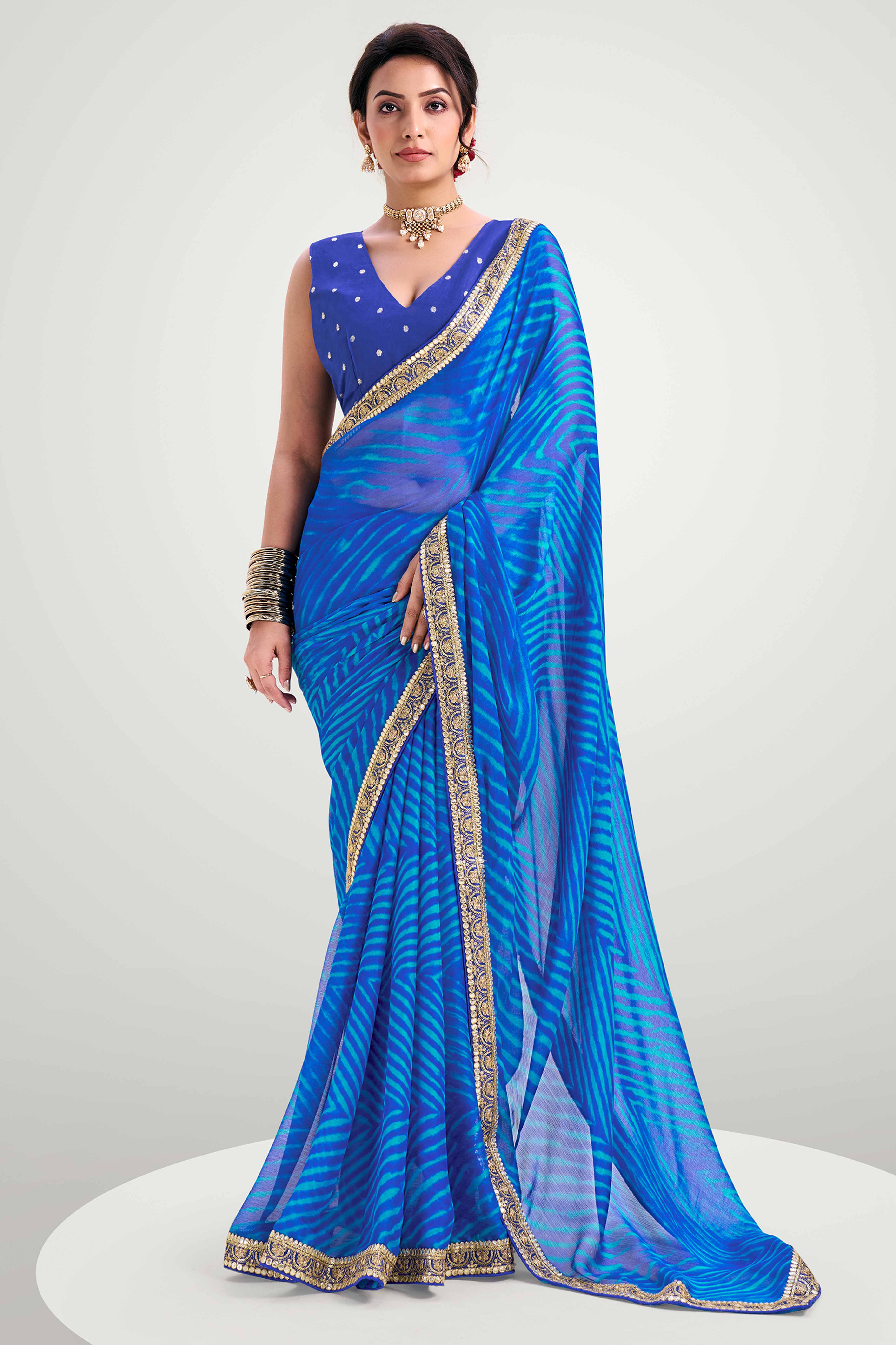 Blue Striped Printed Chiffon Saree Enhanced With Sparkling Sequins Embroidered Border Work