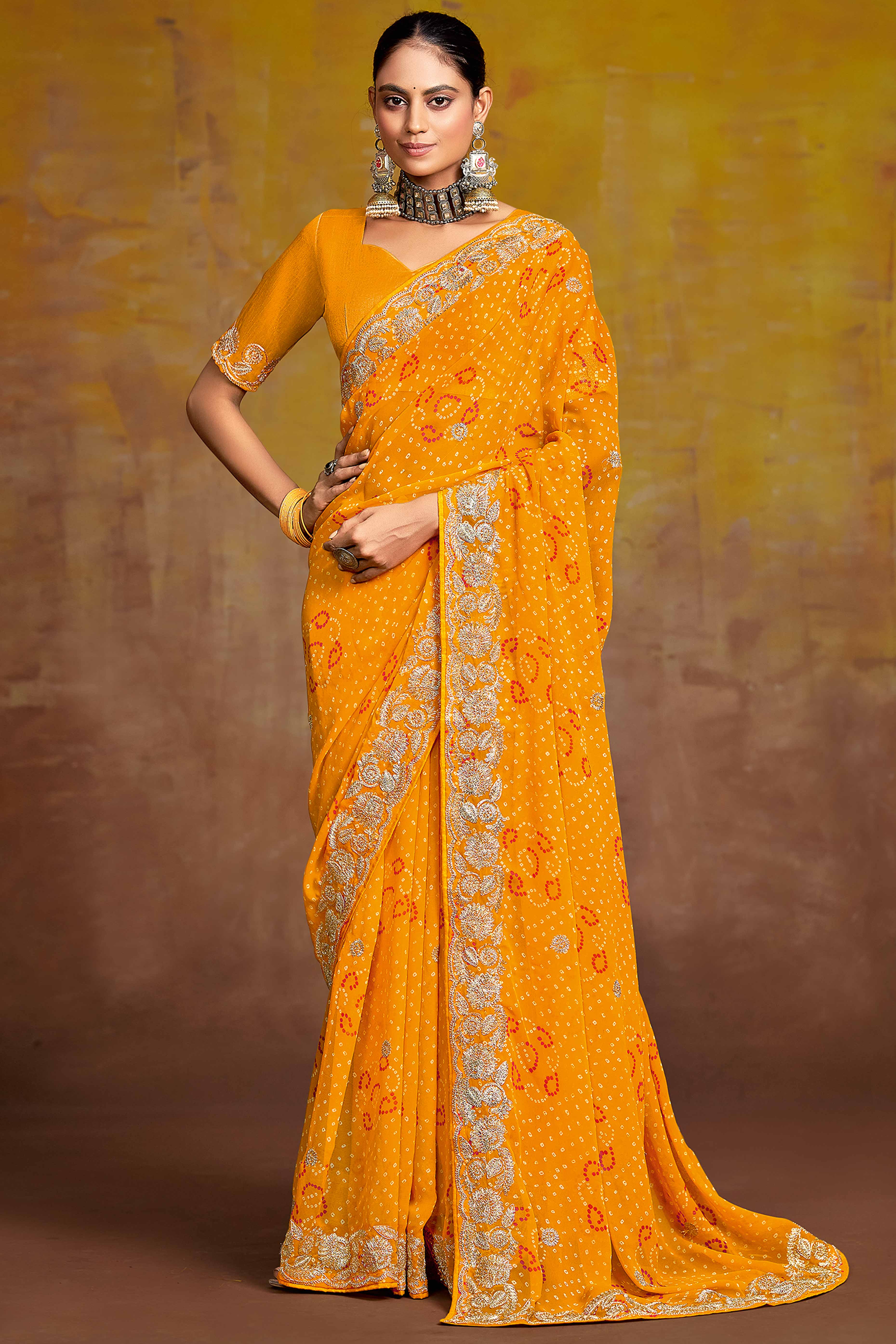 Mustard Georgette Saree Adorned With Traditional Bandhani Prints & Intricate Floral Embroidery