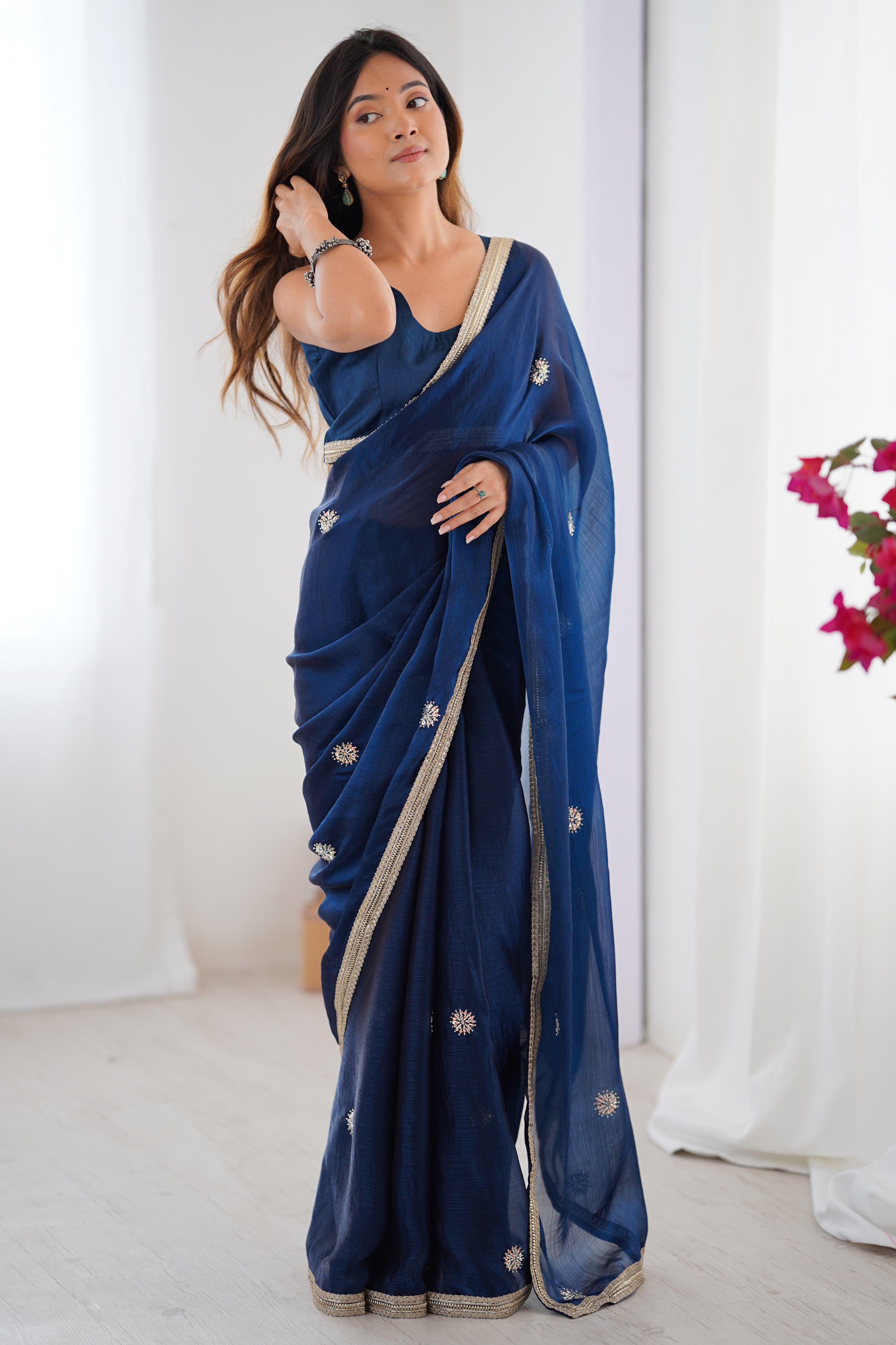 Elegant Blue Organza Saree with Delicate Floral Embellishments and Lace Border