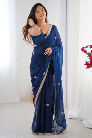 Elegant Blue Organza Saree with Delicate Floral Embellishments and Lace Border