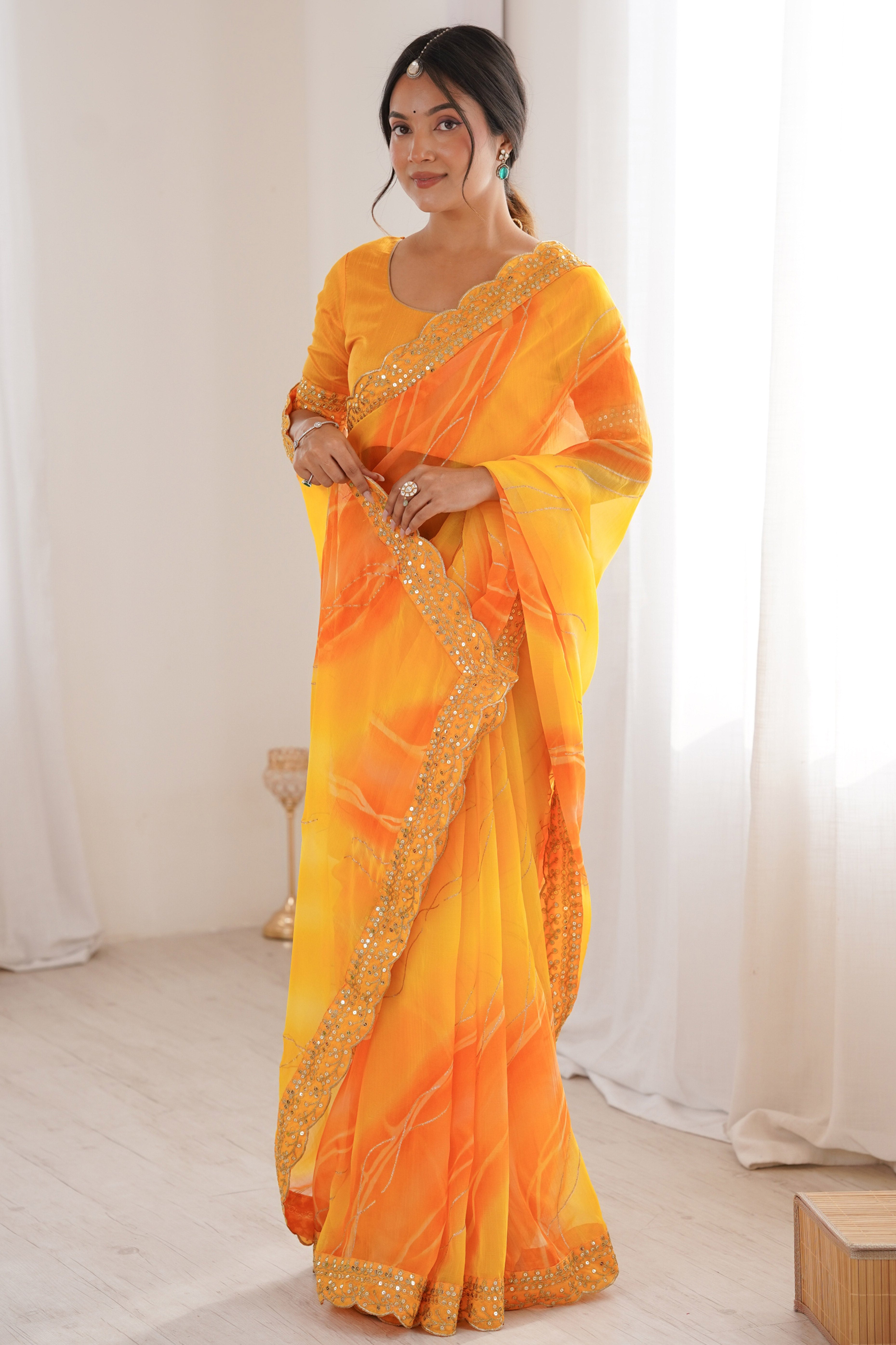 Graceful Yellow Foil Print Georgette Saree Featuring A Luxurious Cording Sequins Embroidered Border