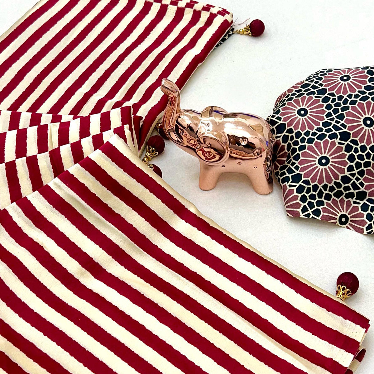 Luxe Partywear Saree in Maroon Satin with Modern Striped Print and Flowing Drape