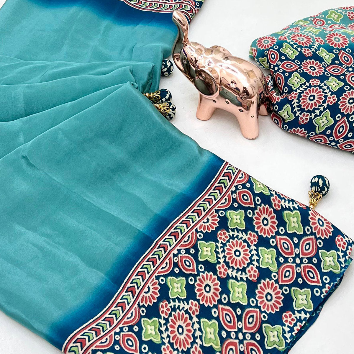 Turquoise Solid Satin Saree Featuring Bold Ajrakh Print and Tassel Accented Pallu