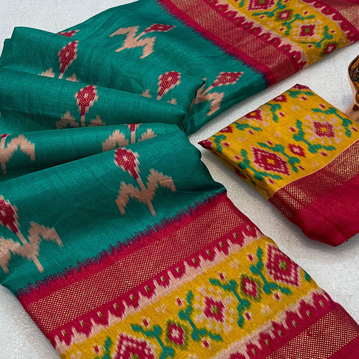 Subtle and Stylish Teal Saree with Ikkat Prints in Luxe Dola Silk for Festive Wear