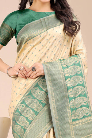 Cream Banarasi Silk Saree Featuring Lustrous Green Floral Zari Weaving and a Rich Contrast Border