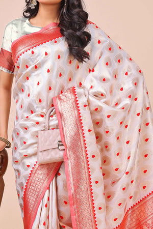 White Banarasi Silk Saree With Intricate Floral Weave & Elegant Tassel Accents