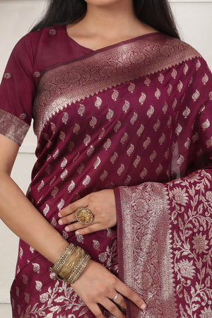 Wine Traditional Lichi Silk Blend Saree Enhanced With Floral Zari Weaving & Tassel Pallu