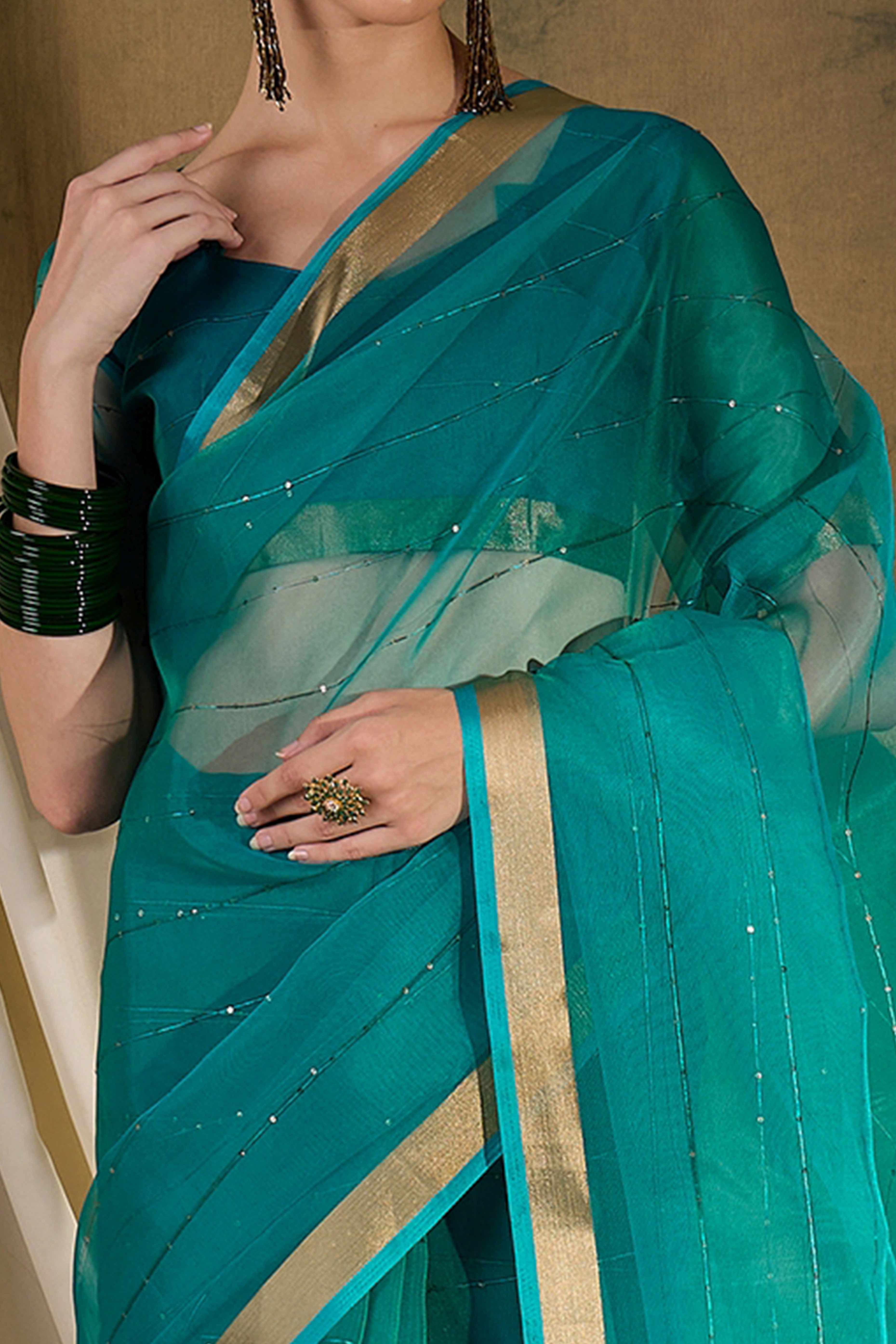 Teal Organza Silk Saree Featuring Shimmering Sequins Embroidery & Elegant Tasselled Pallu
