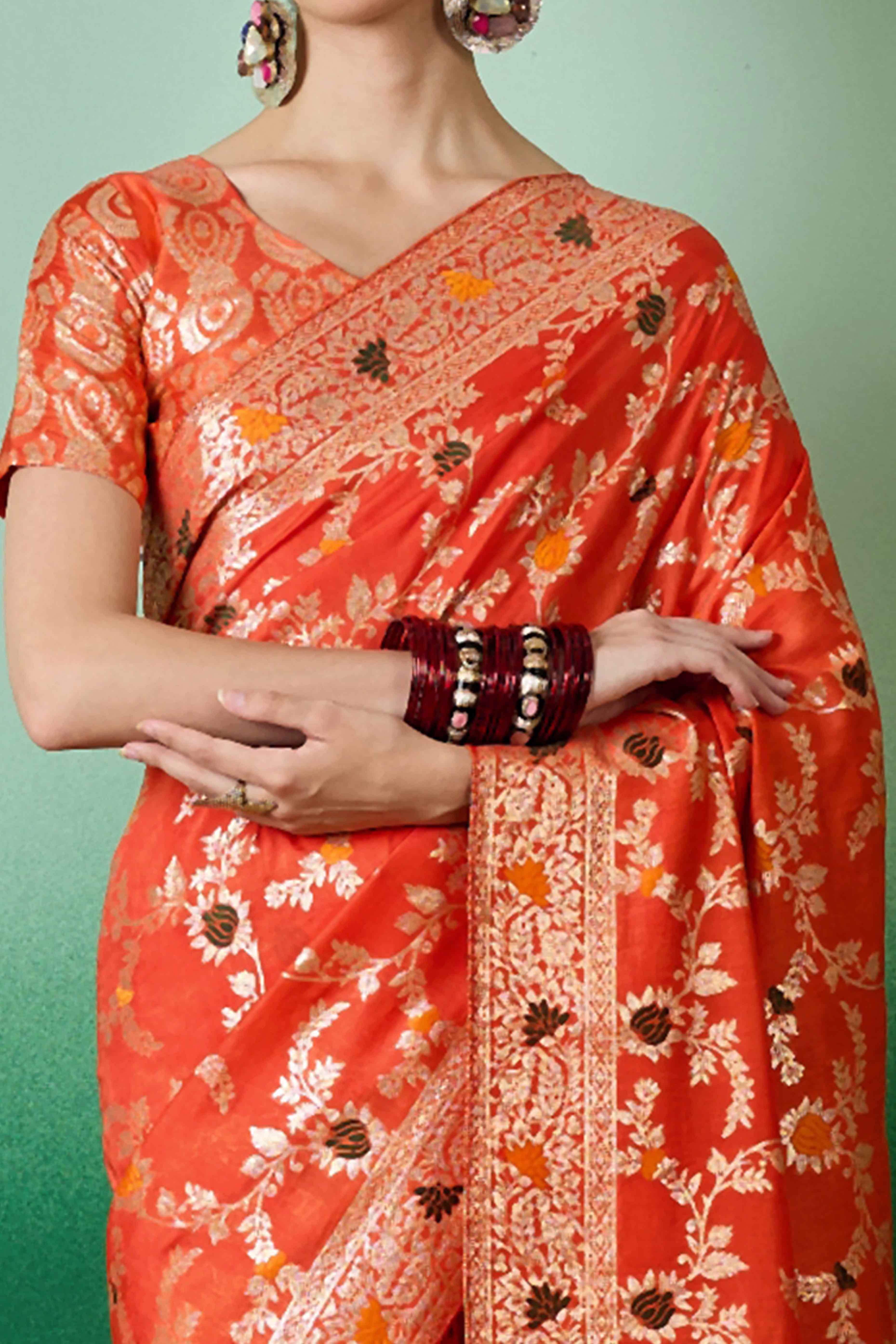 Orange Cotton Meena jacquard Saree Featuring Intricate Floral Weaving & Playful Tassels On The Pallu