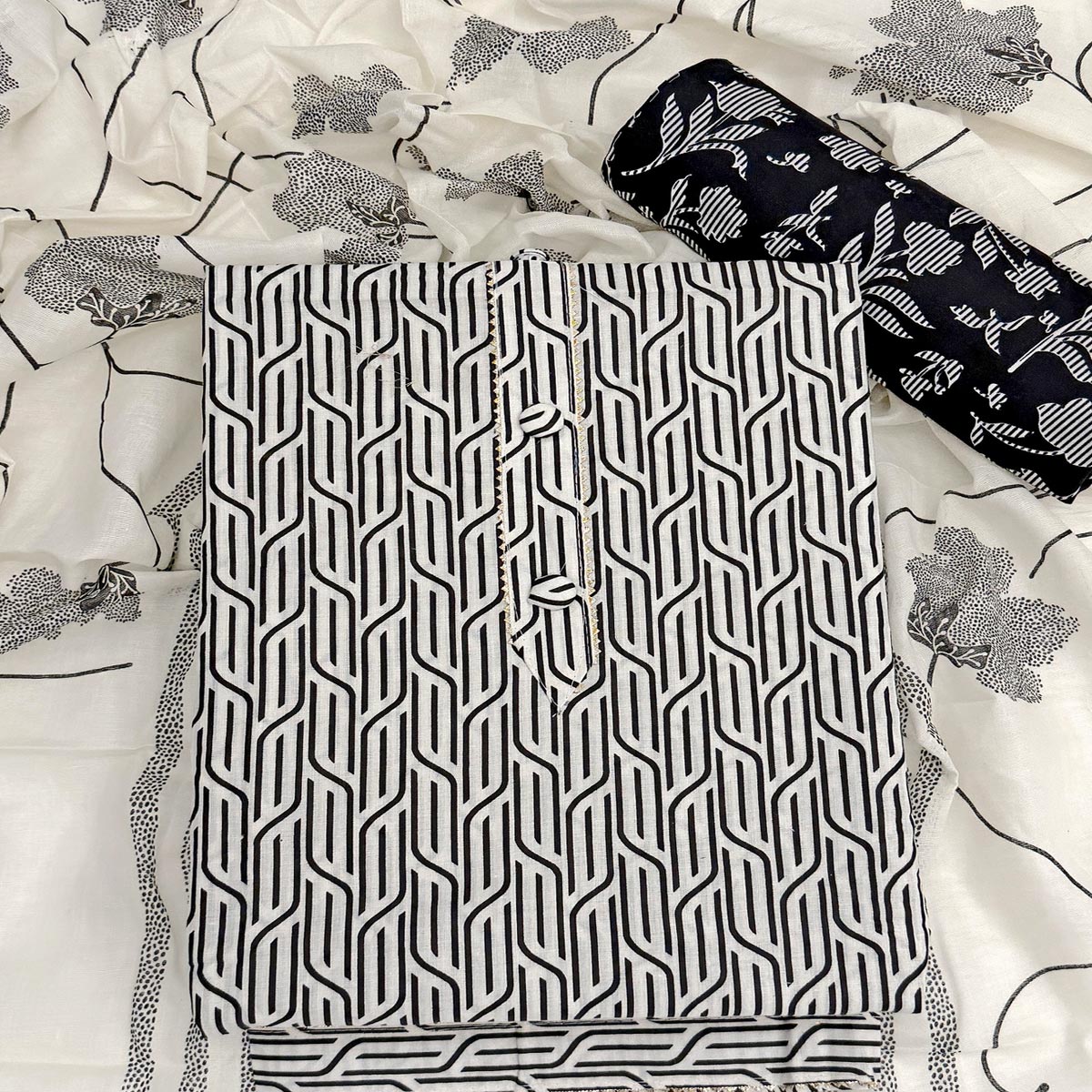 Trendy Black Geometric Print Pure Cotton Dress Material Featuring Stylish Tie Neck & Fancy Button