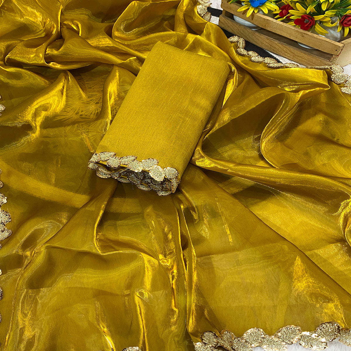 Gold Tissue Saree Featuring Solid Finish and Delicate Lace Work by Jimmy Choo Style