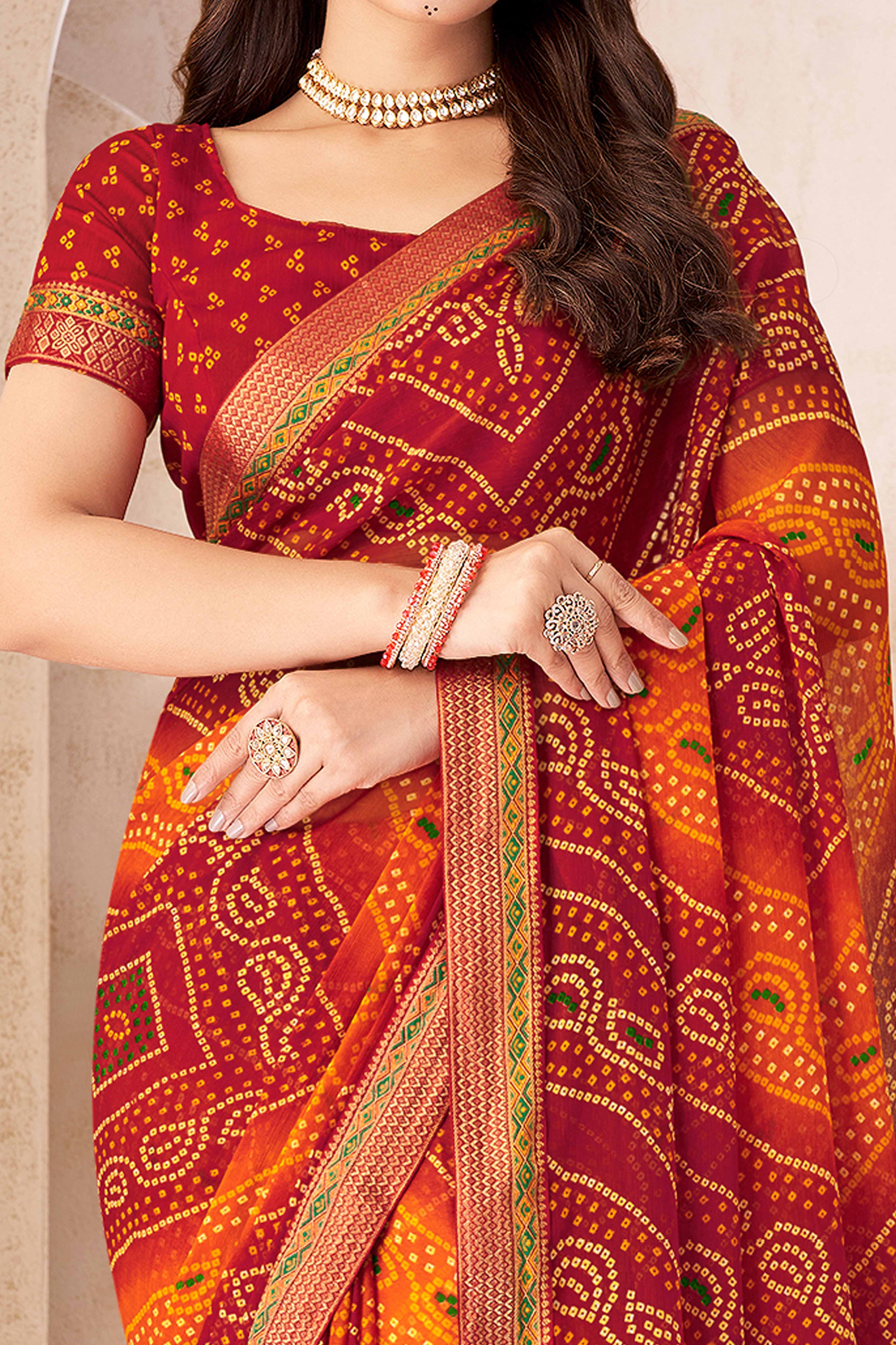 Maroon & Orange Bandhani Printed Chiffon Saree Enhanced with Delicate Lace Border Work