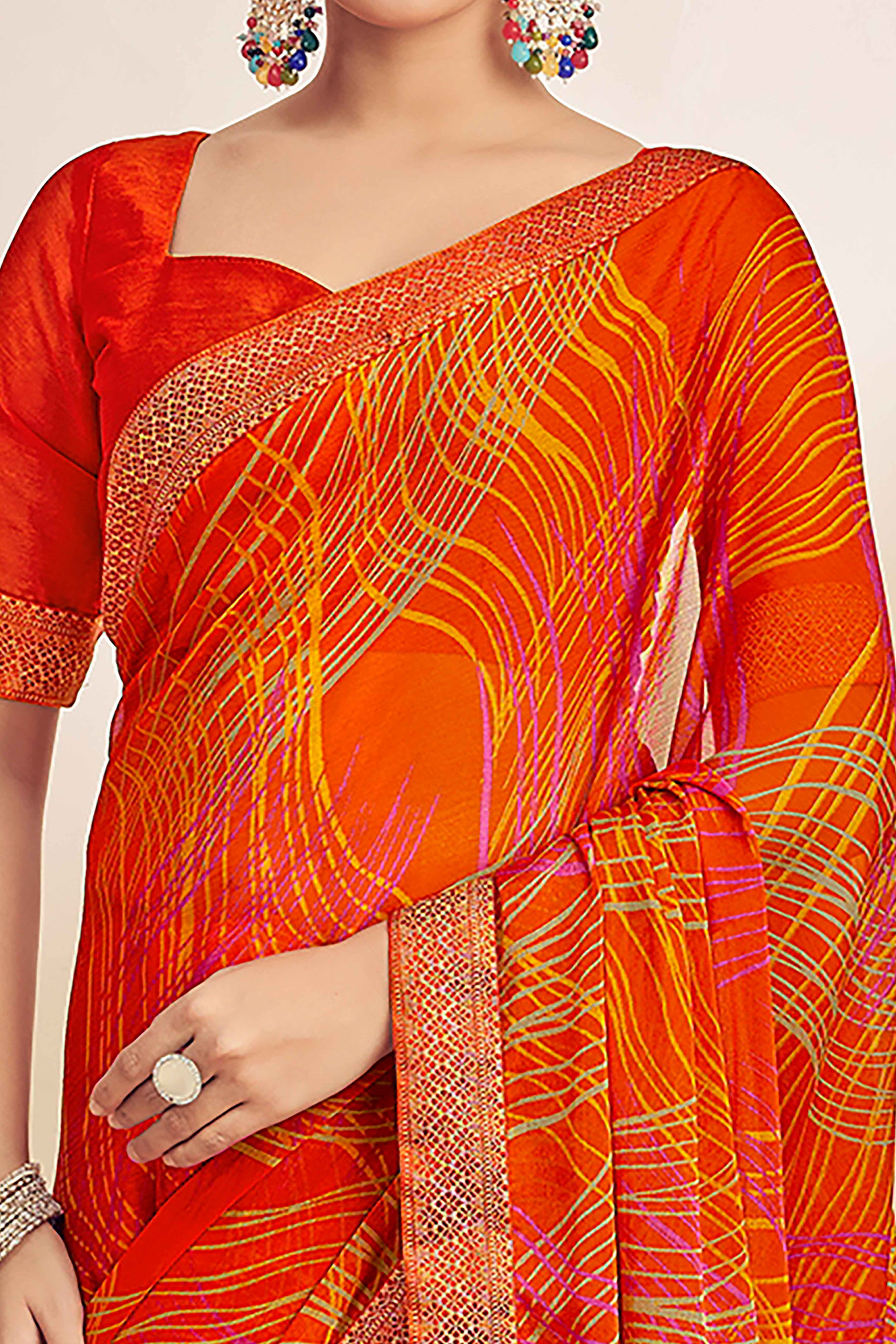 Orange Chiffon Saree Adorned With Artistic Print & Finely Crafted Woven Lace Border