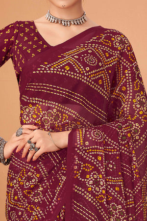 Maroon Bandhani Printed Chiffon Saree Accented With Intricate Lace Border Work