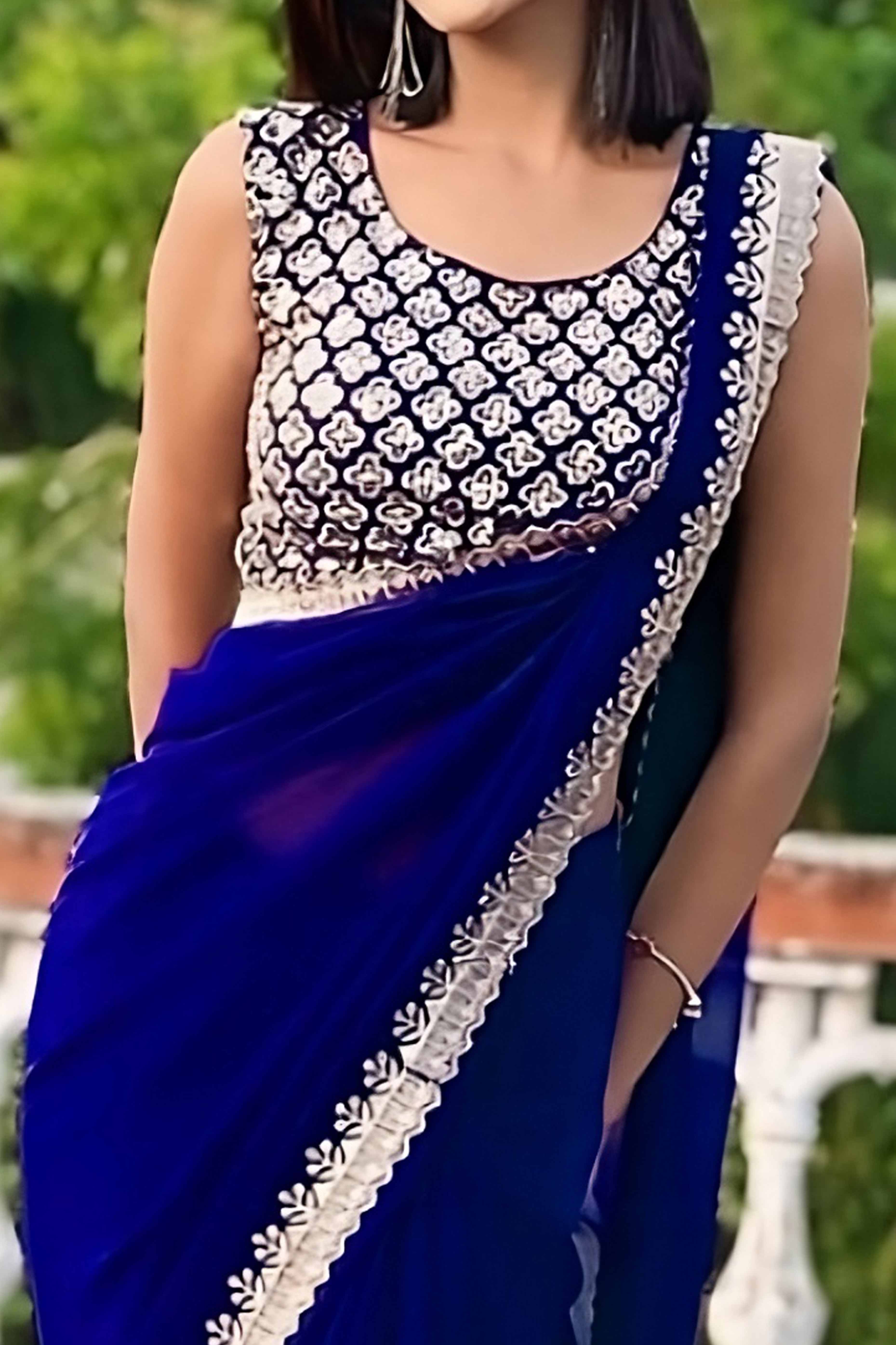 Blue Georgette Saree With Sleek Solid Finish And Embroidered Edging