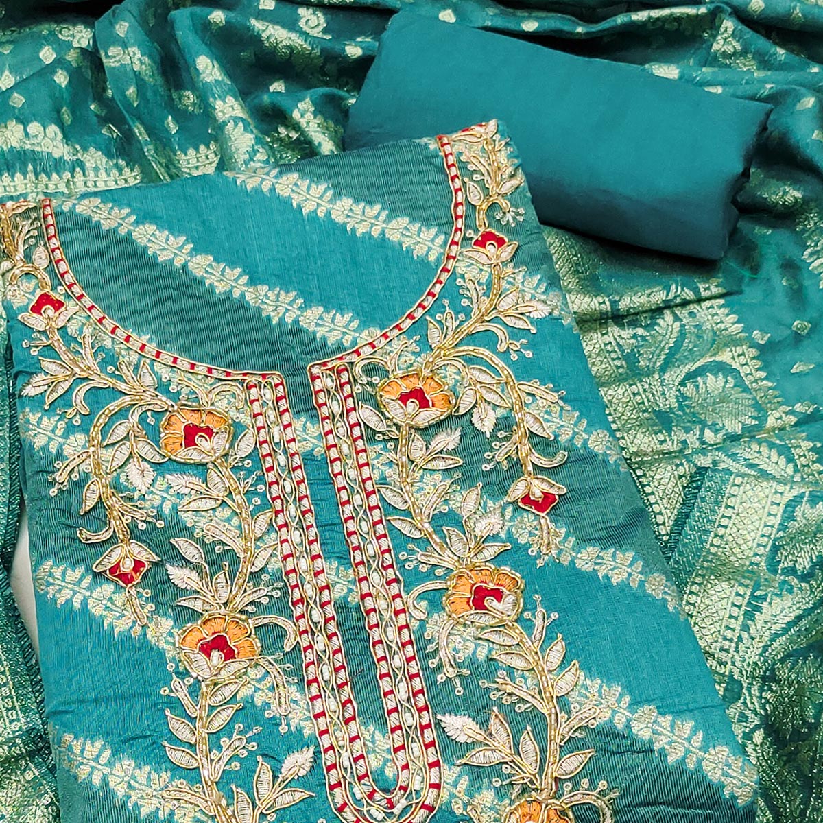 Rama Green Shimmer Cotton Silk Suit Material Featuring Zari Weaving and Artistic Embroidered Detailing