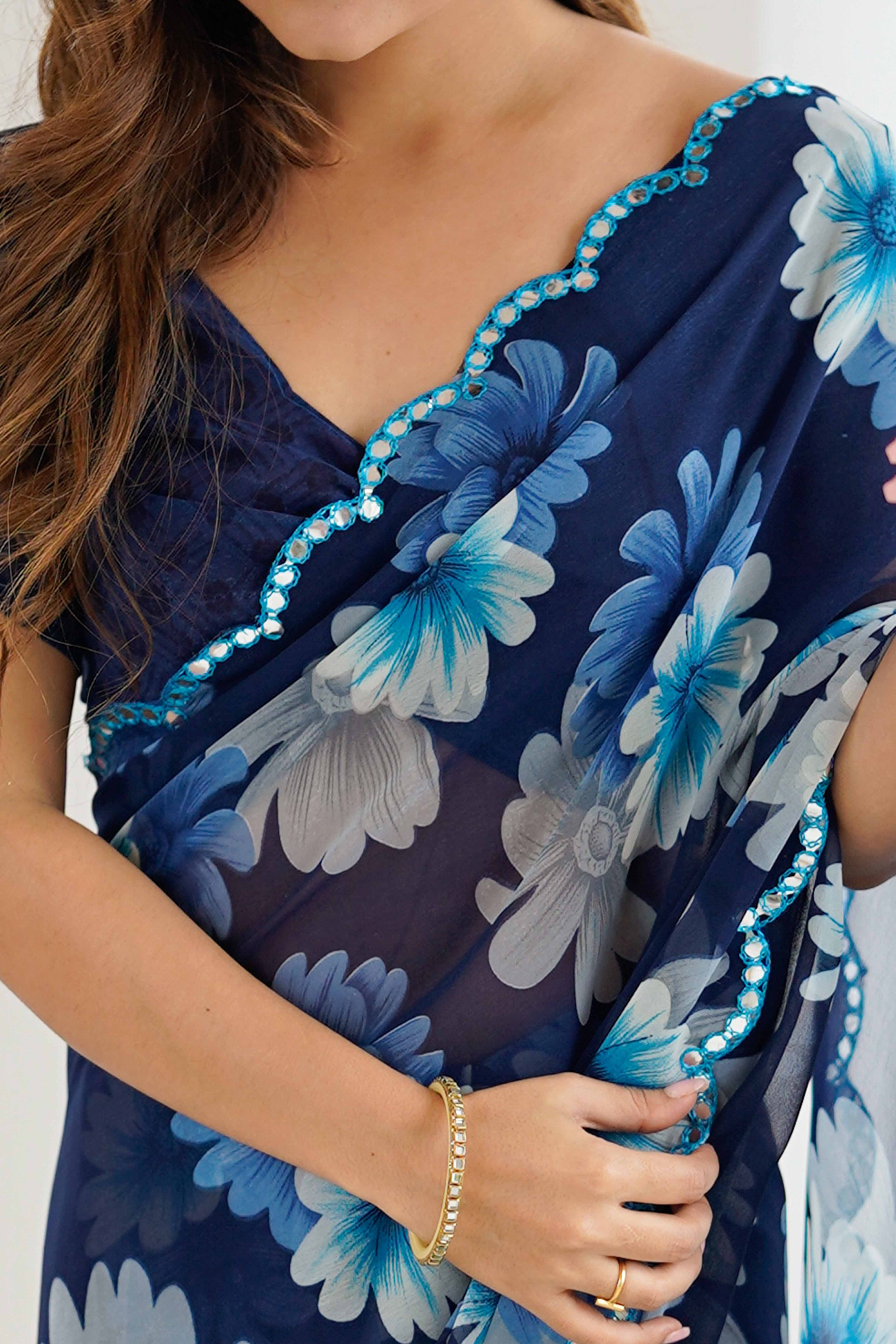 Blue Georgette Saree Featuring Floral Prints & Shimmering Mirror Work Border