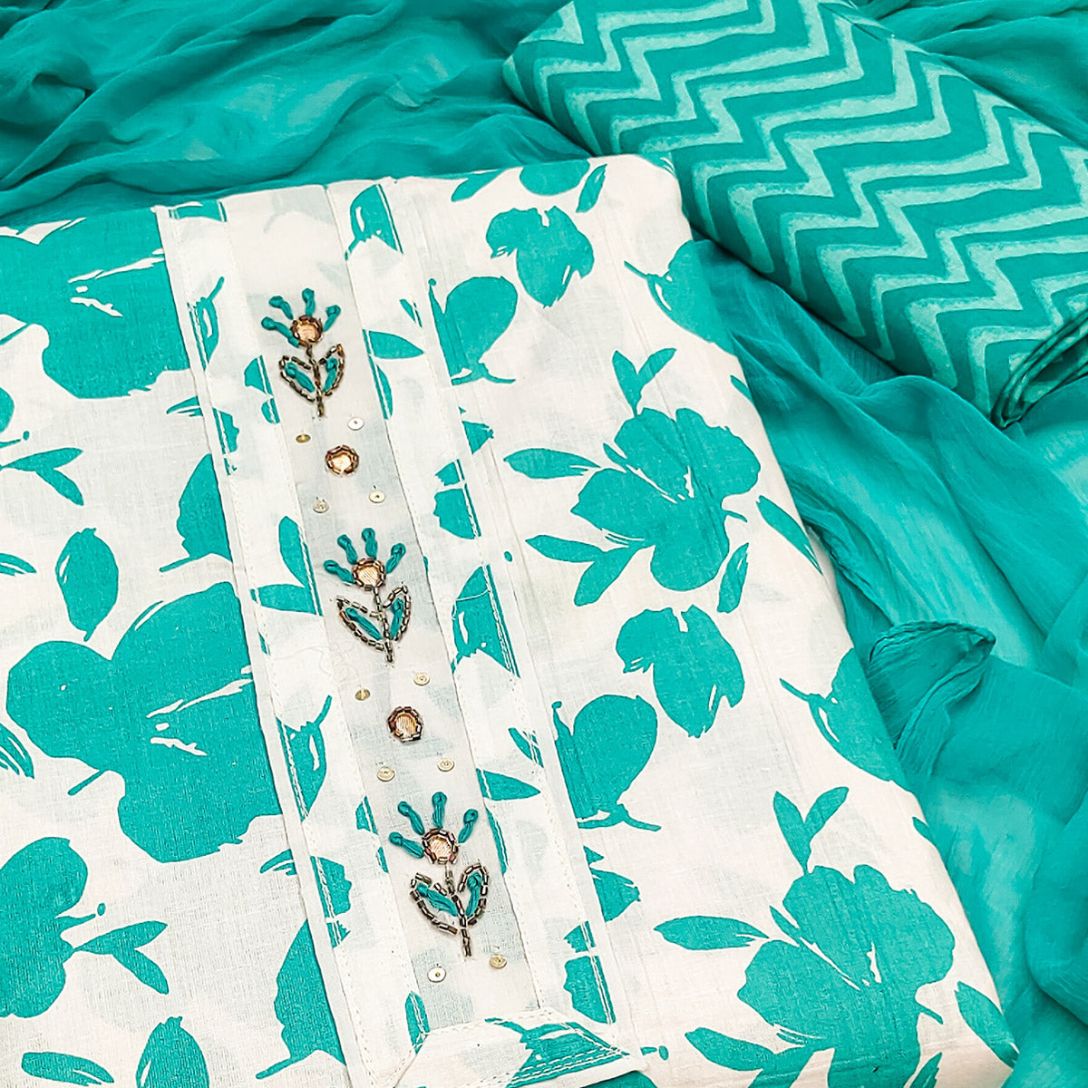 White Base Pure Cotton Dress Material Accented with Beautiful Turquoise Florals