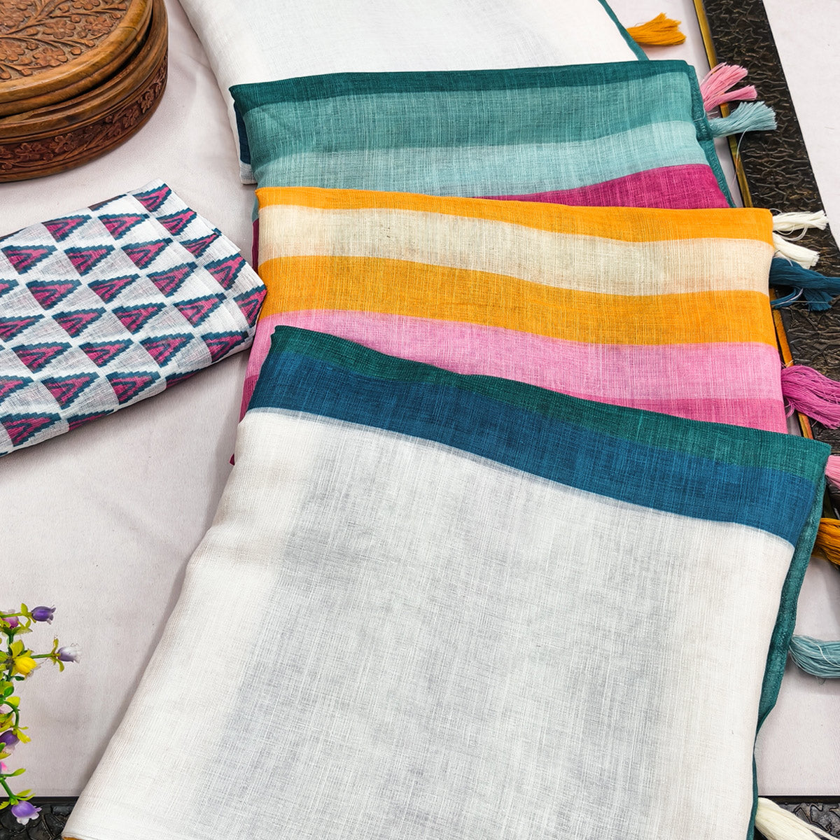 White Linen Saree Designed with Modern Striped Prints and Trendy Tassel Detailing