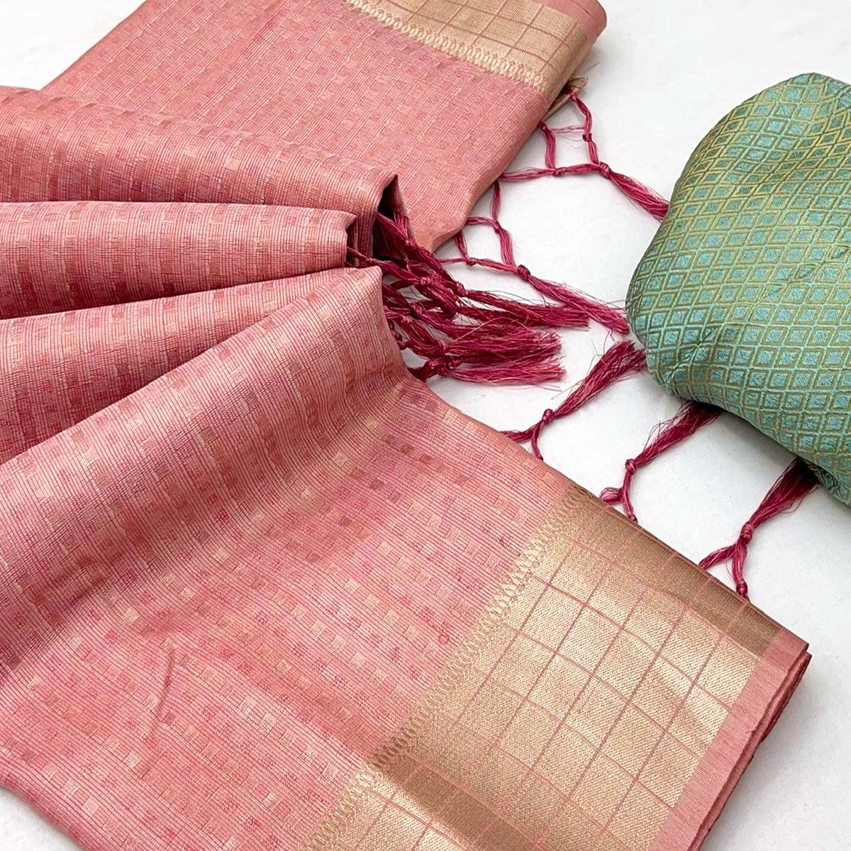 Peach Soft Tissue Saree Featuring Rich Zari Woven Detailing.