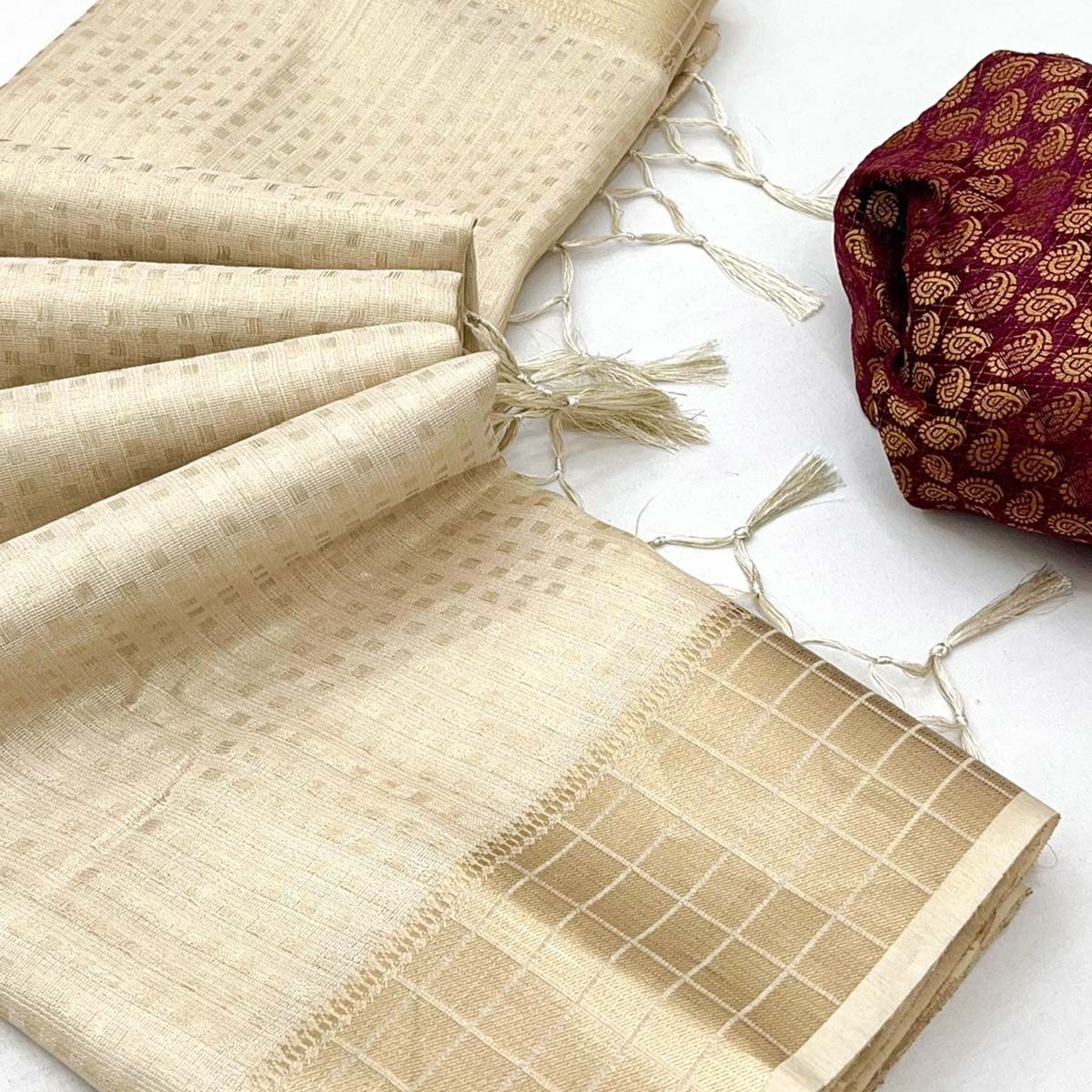 Cream Soft Tissue Saree Featuring Rich Zari-Woven Detailing.