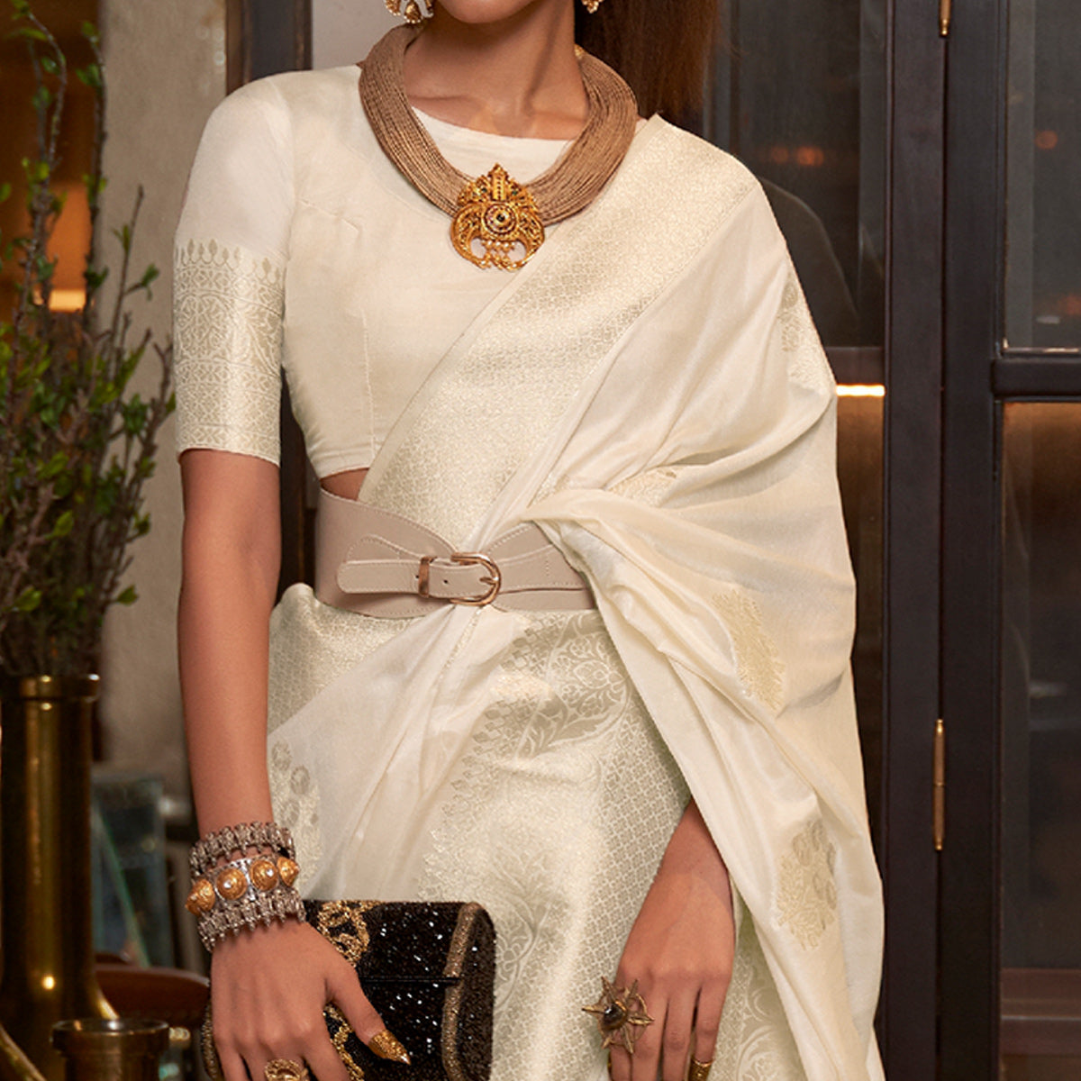 Cream Woven Georgette Saree With Tassels