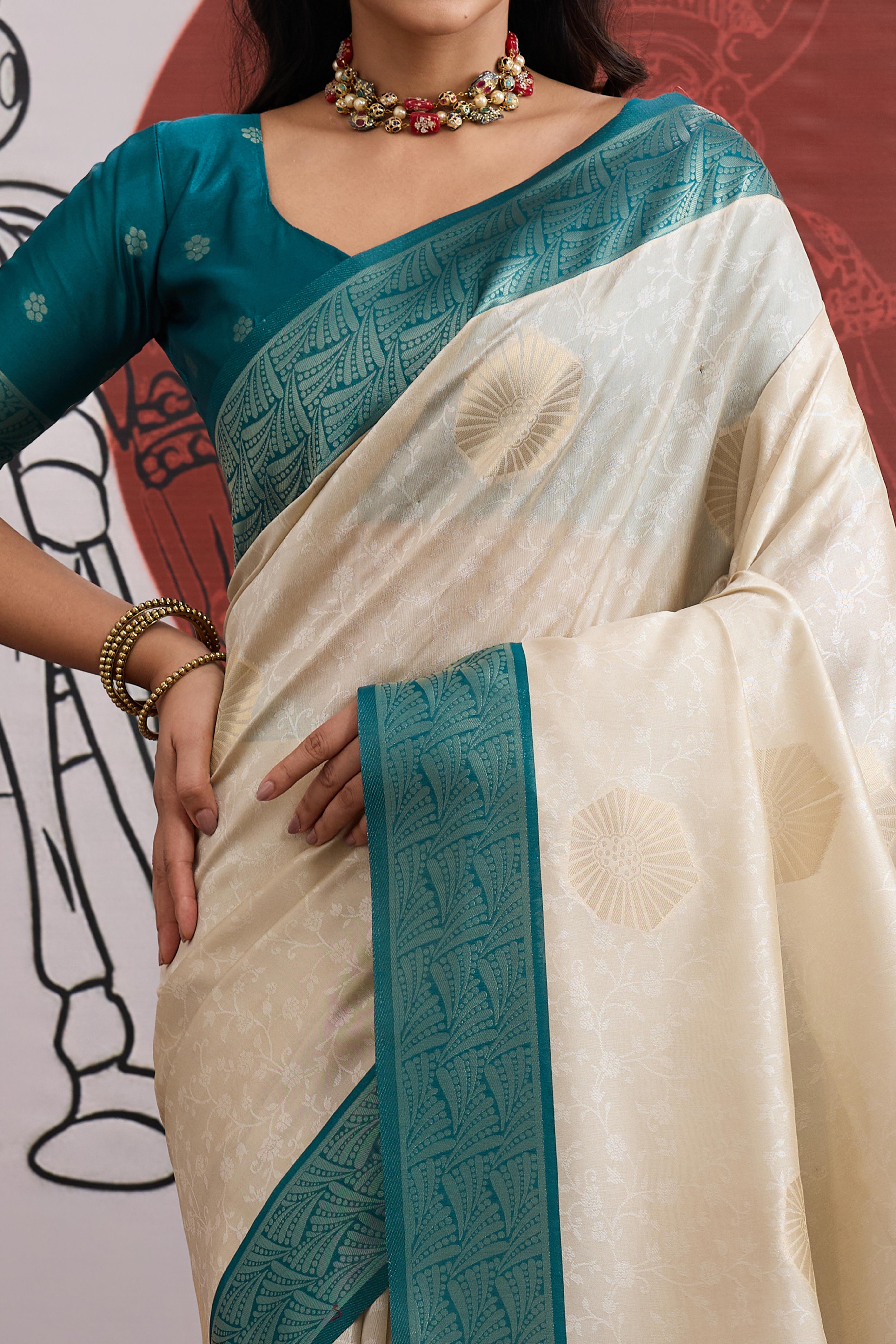 Graceful Cream & Teal Zari Weaving Silk Saree Highlighted By Decorative Tassel Pallu