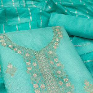 Ethereal Turquoise Banarasi Jacquard Dress Material Adorned With Ornate Zari Floral Weaves