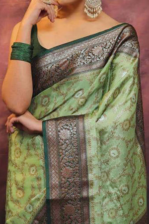 Elegant Green Floral Zari Woven Lichi Banarasi Silk Saree With Intricate Detailing